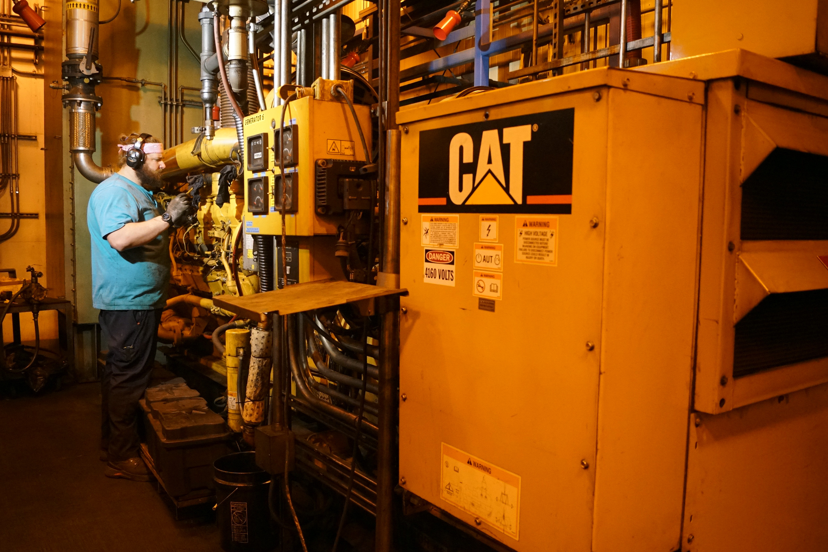 A mechanic works on power plant generators.