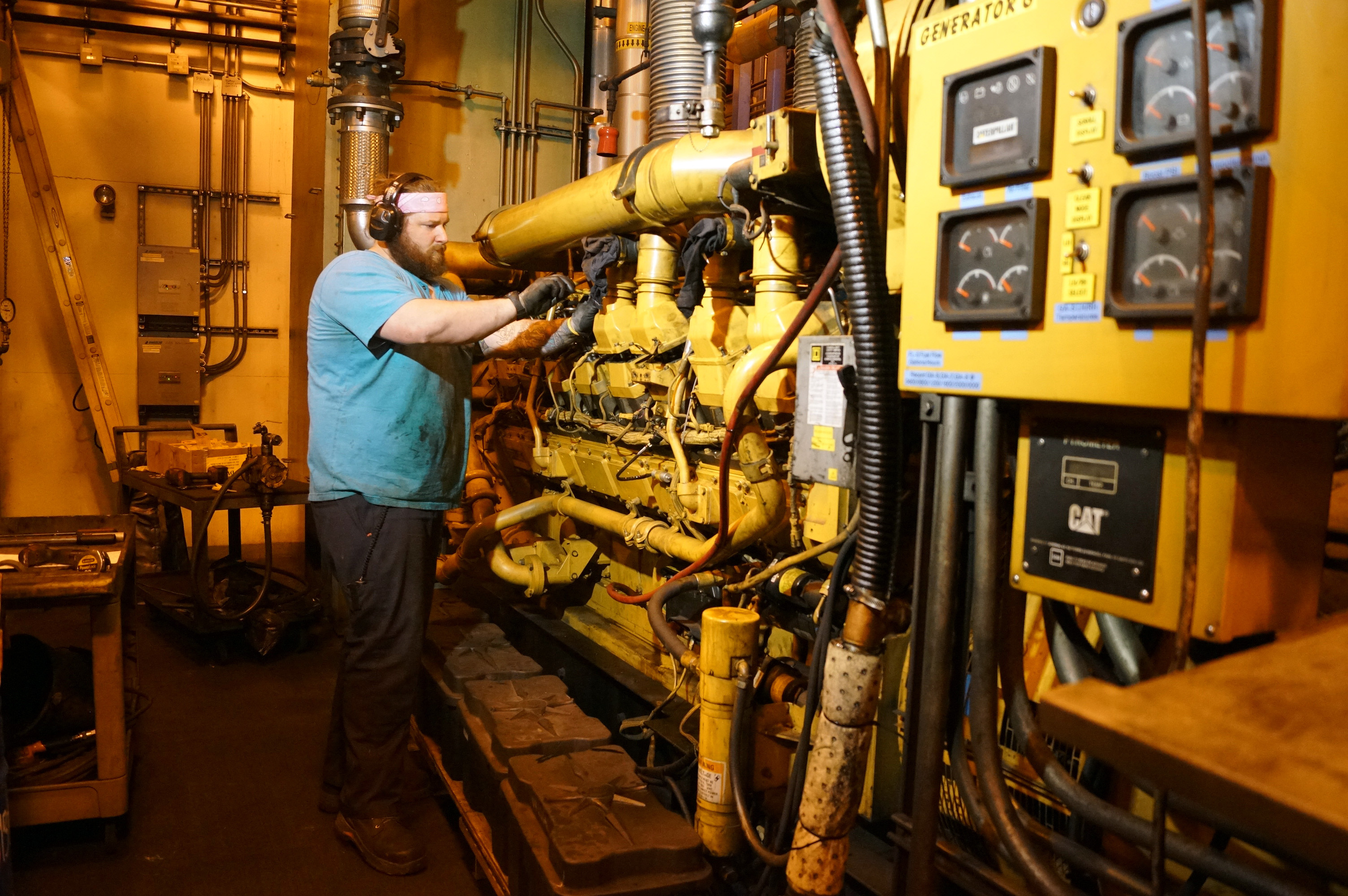 A mechanic works on power plant generators.