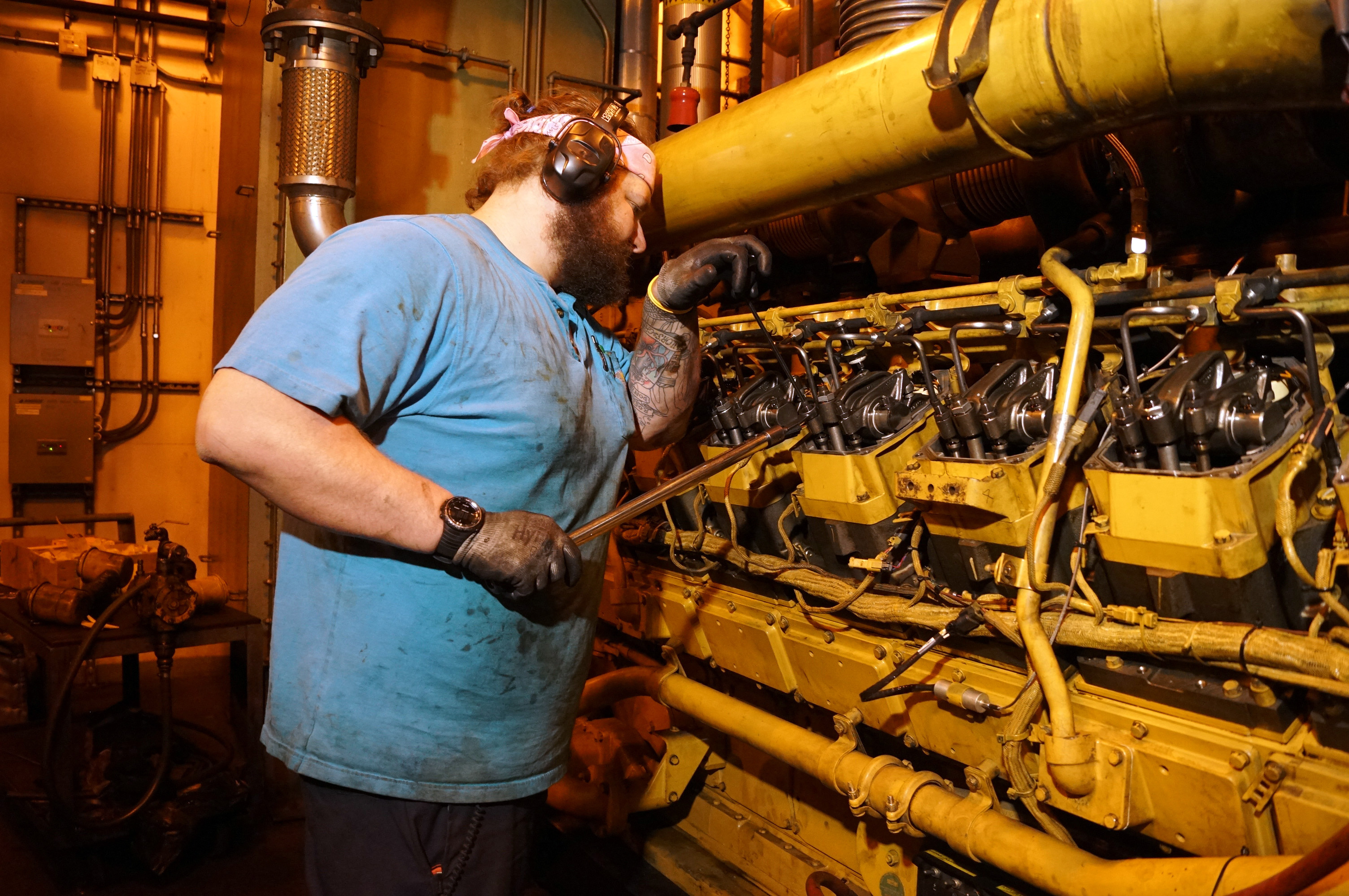 A mechanic works on power plant generators.