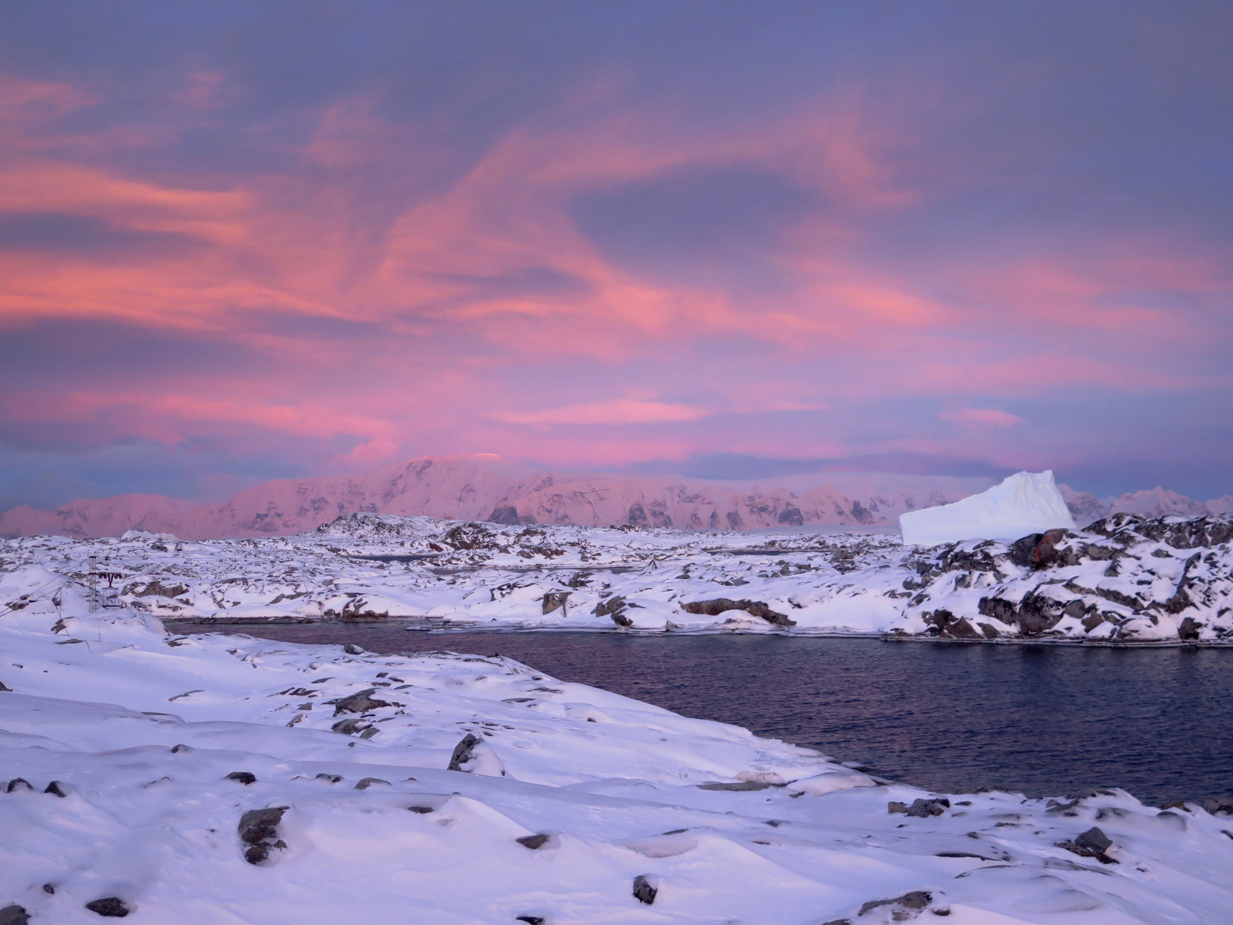 Sunset over snow-covered land.