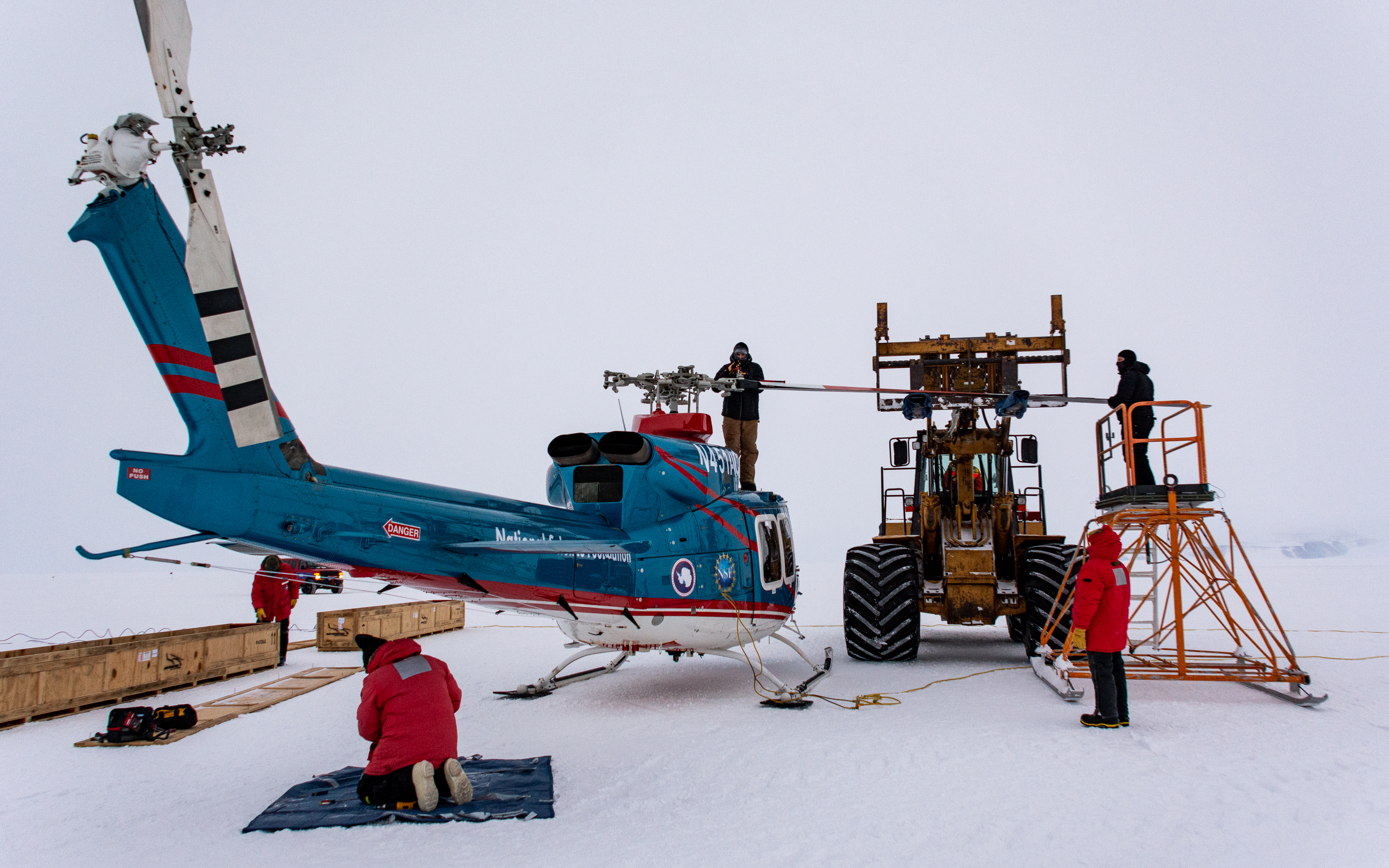 Workers assembling a helicopter.
