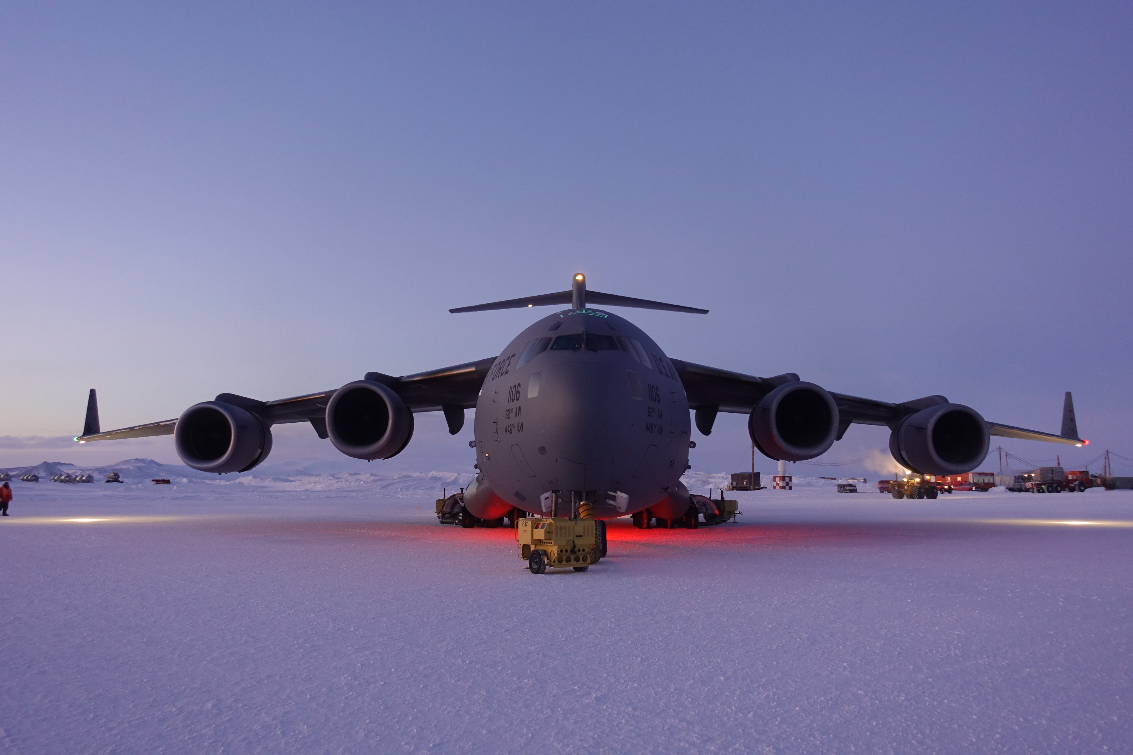 A lage cargo jet sits on ice.