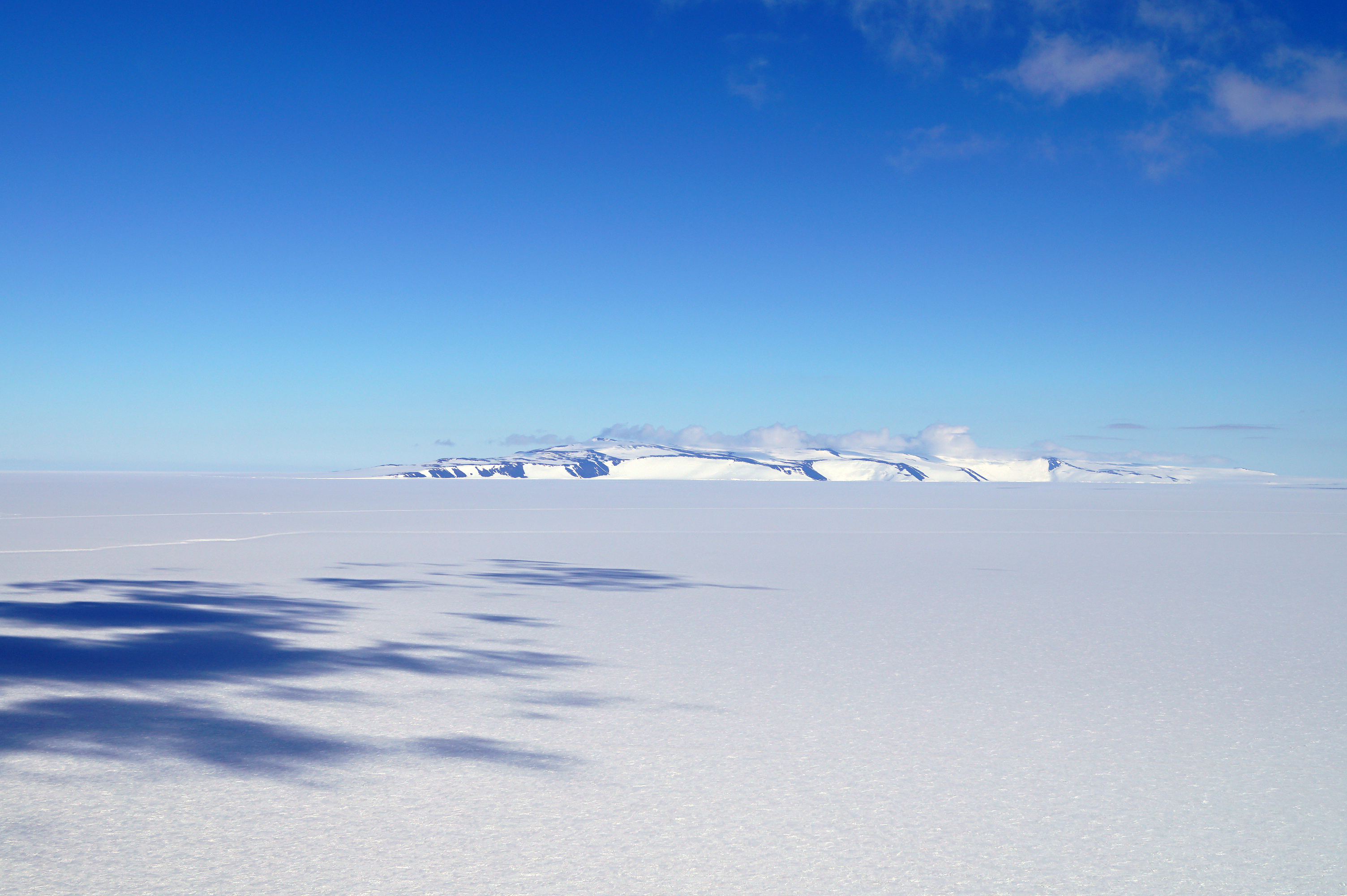 A flat landscape covered with snow.