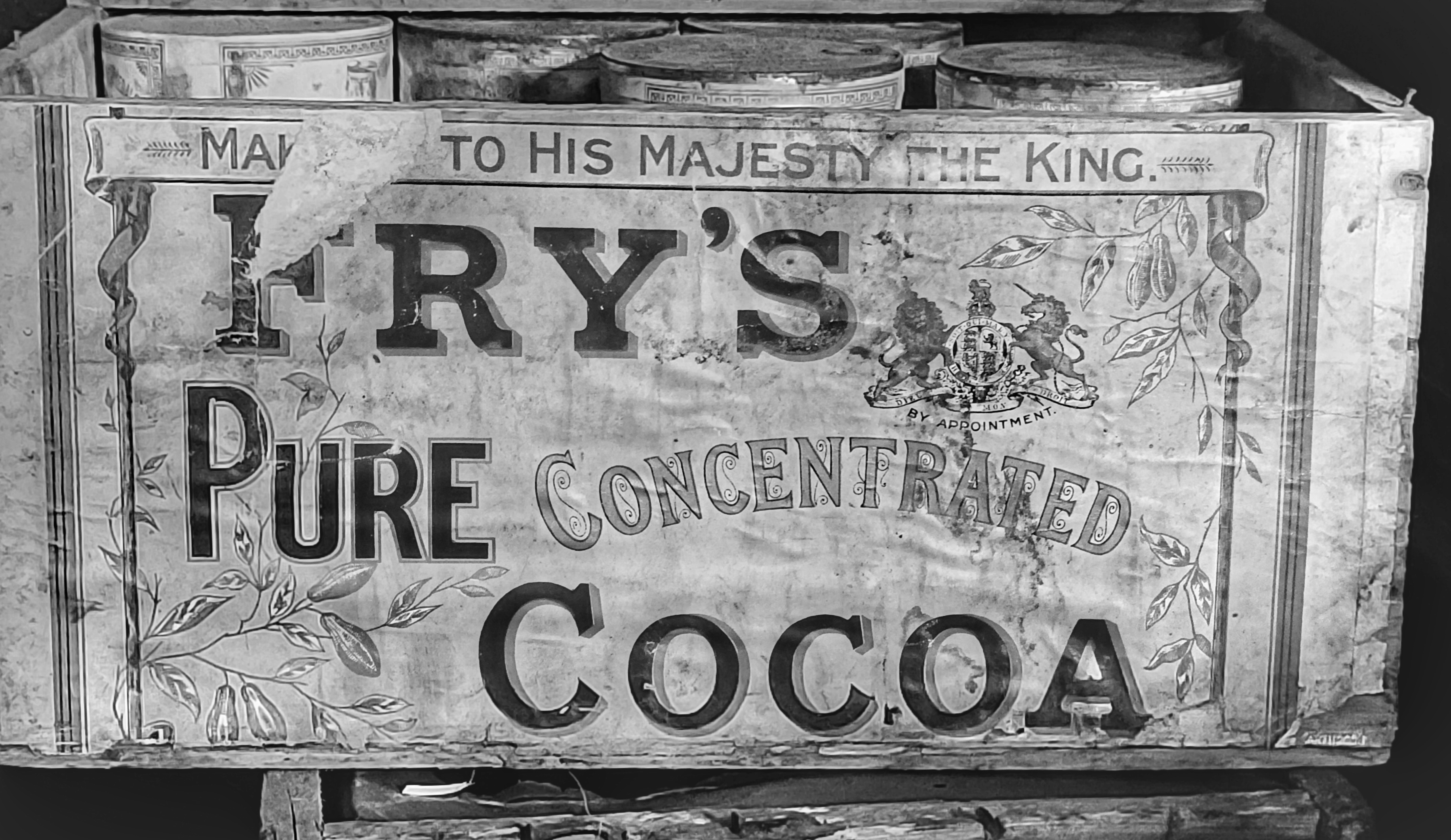 A black and white image of a wooden box containing cocoa.