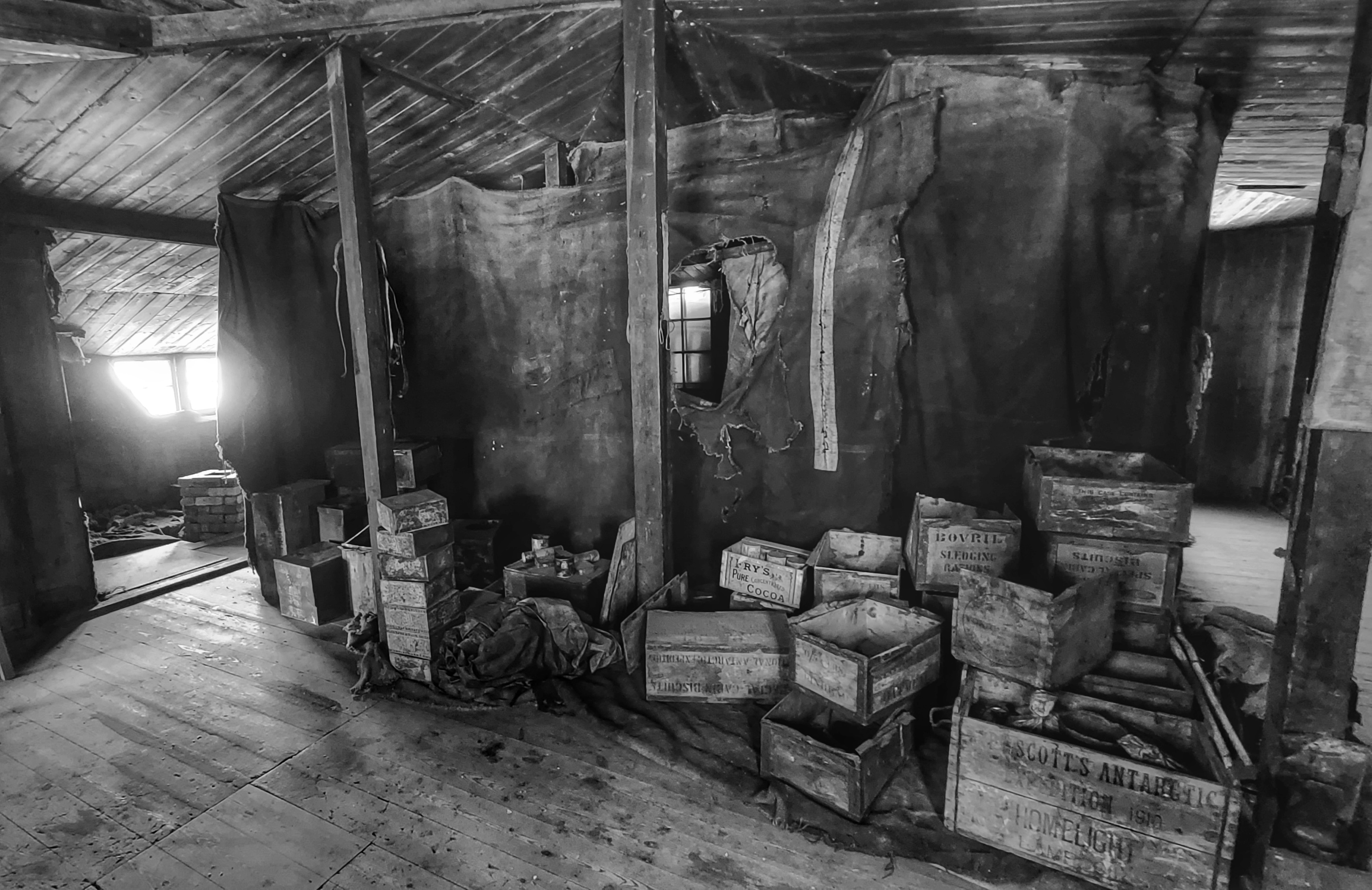 Old wooden crates inside an old hut.