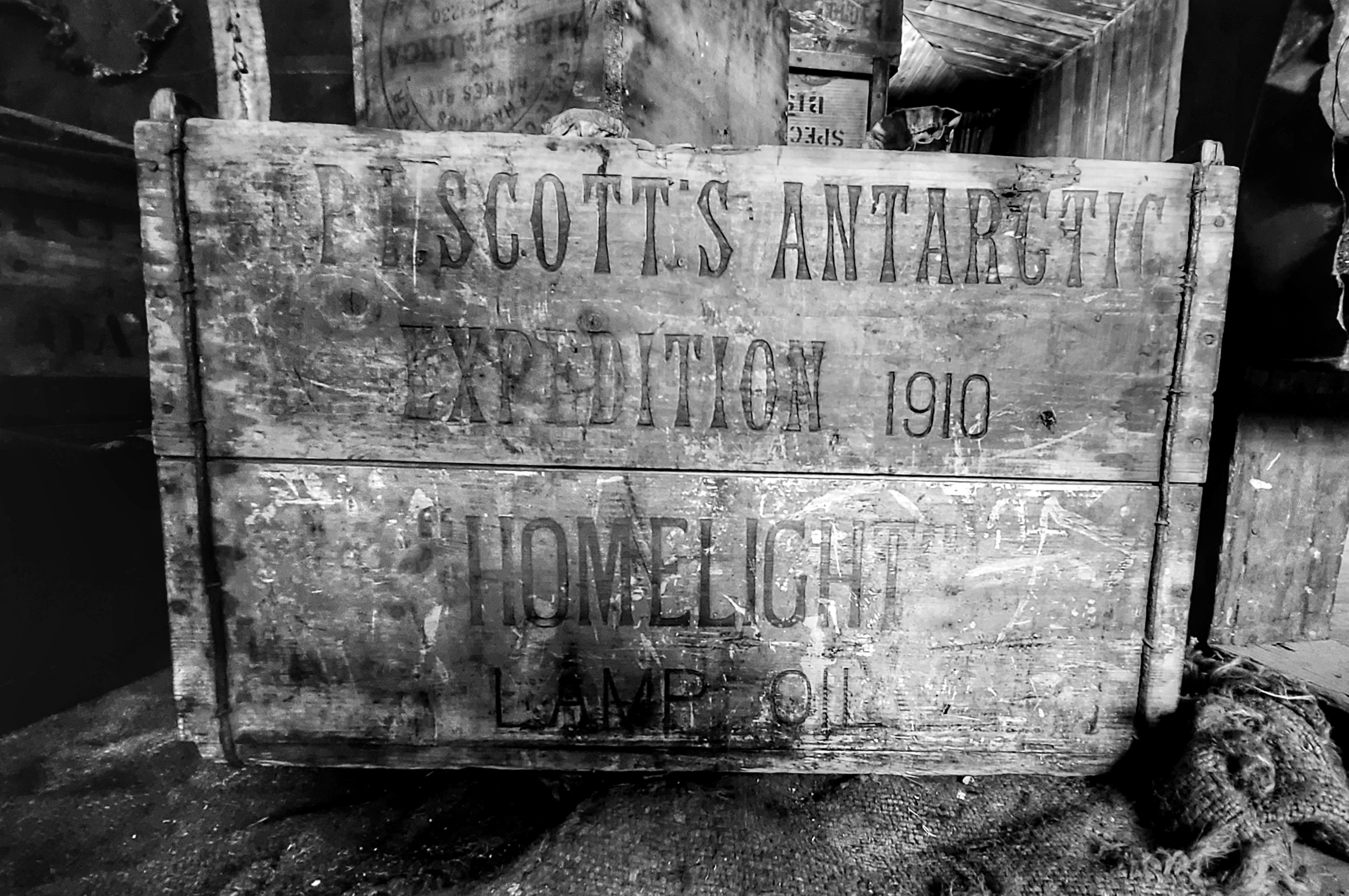 A black and white image of an old wooden crate.