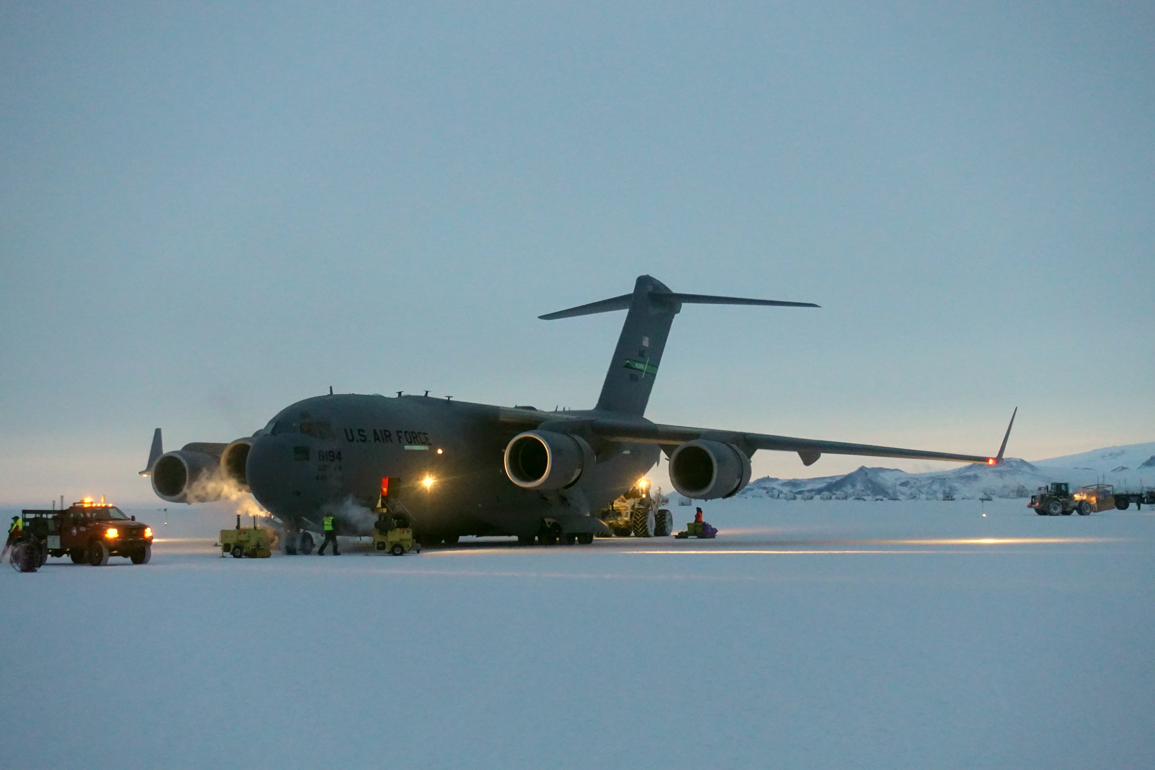 A large jet on a flat white field of ice.