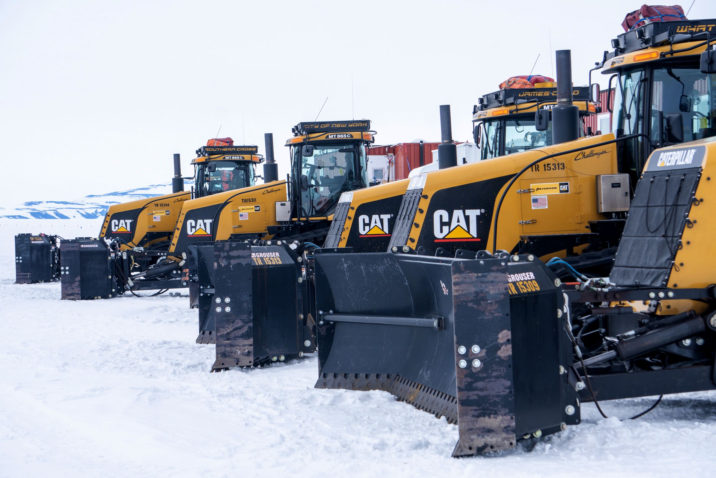 Large Caterpillar tractors lined up.