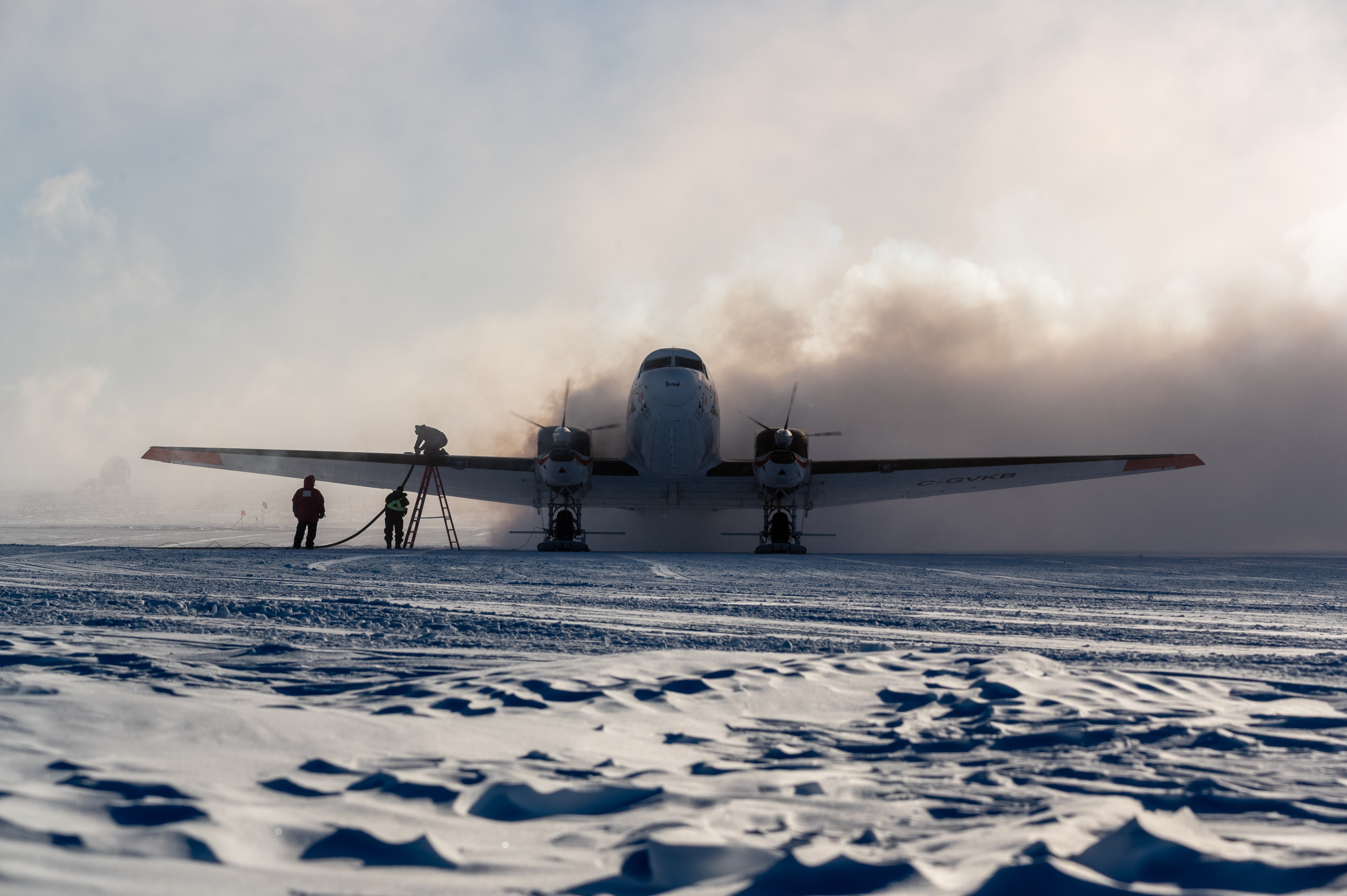 An airplane landing on snow.