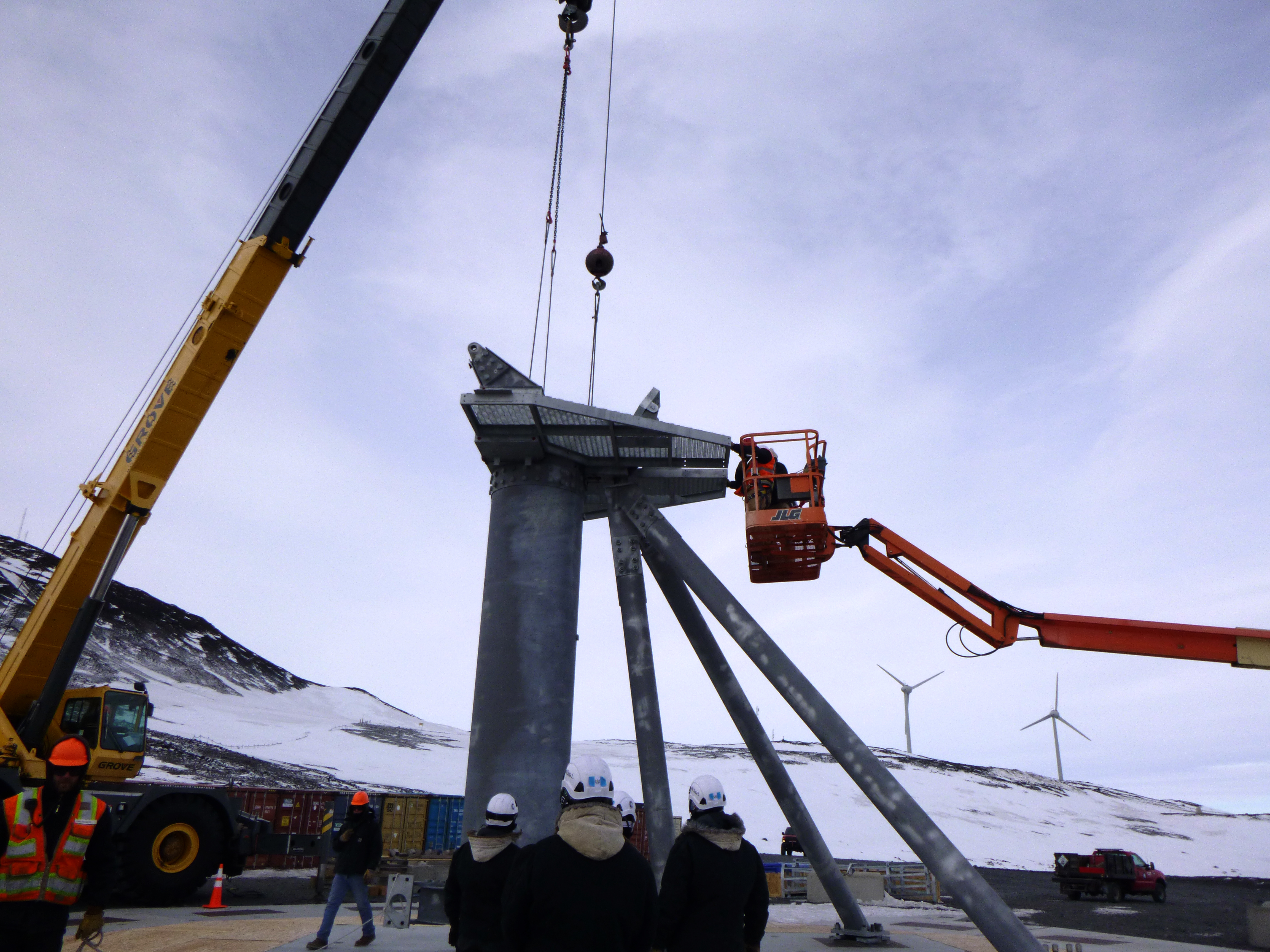 Workers construct a large pedestal.