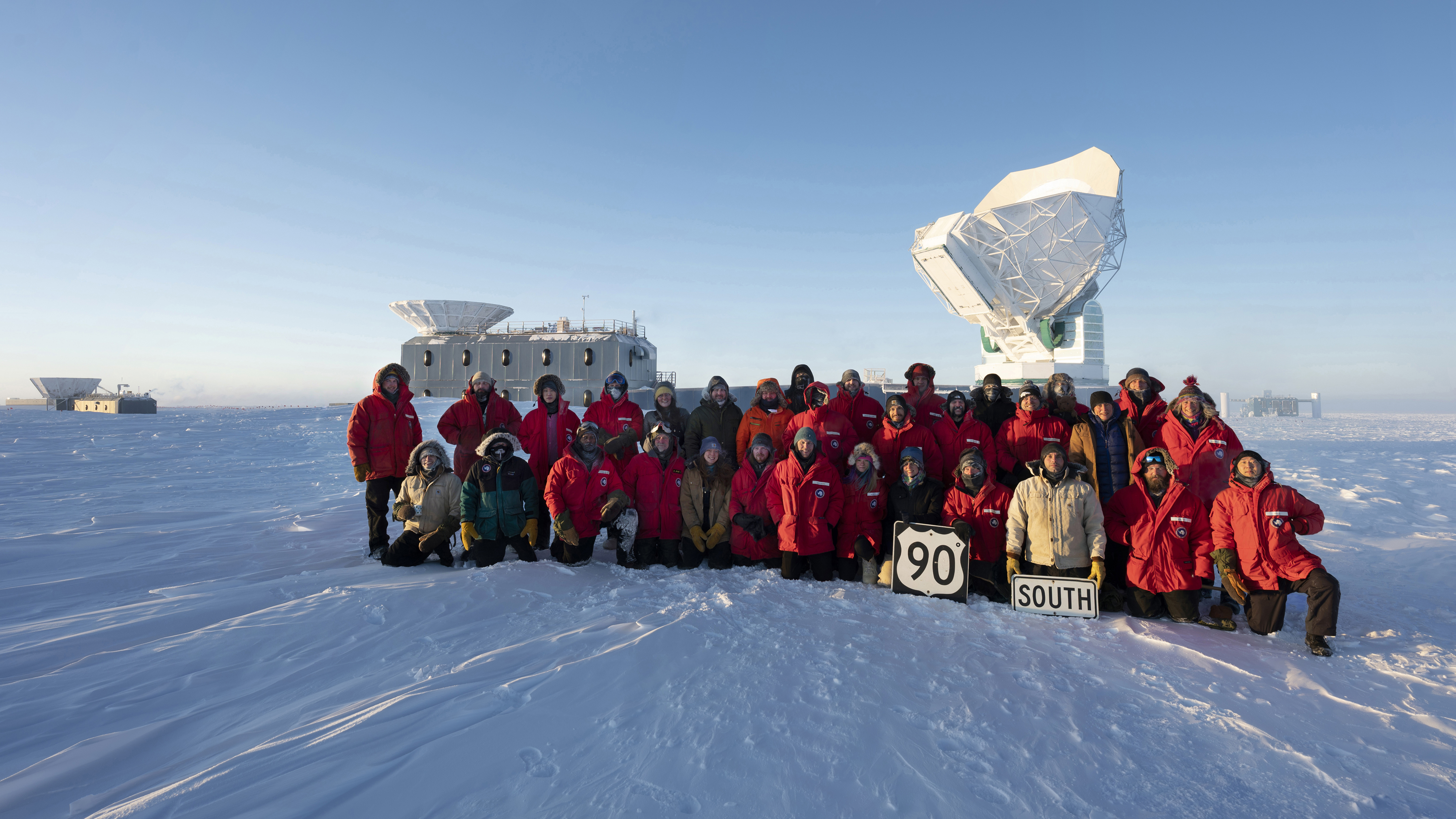 A group of people posing in the freezing cold for a photo.