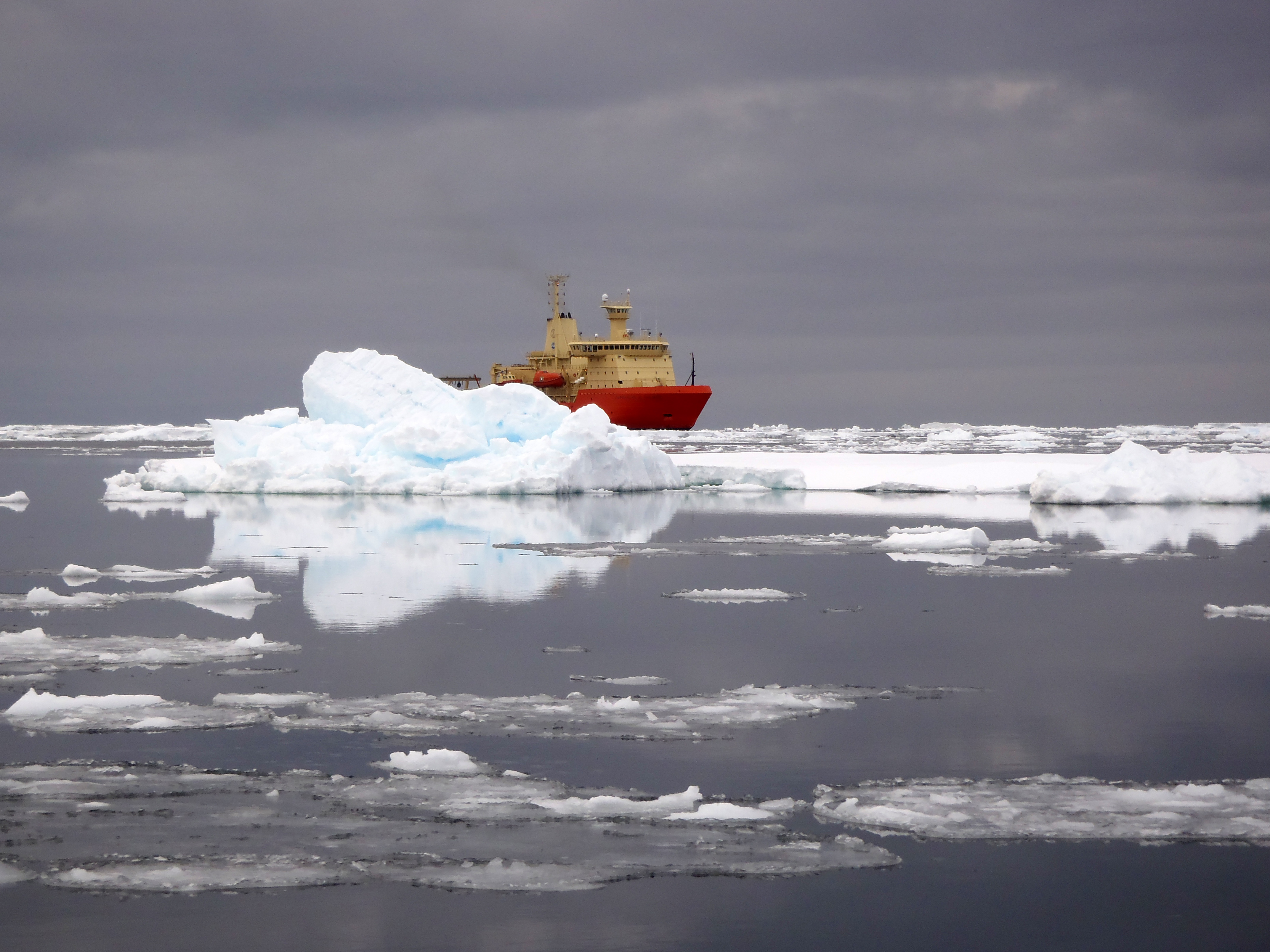 A ship surrounded by icebergs.