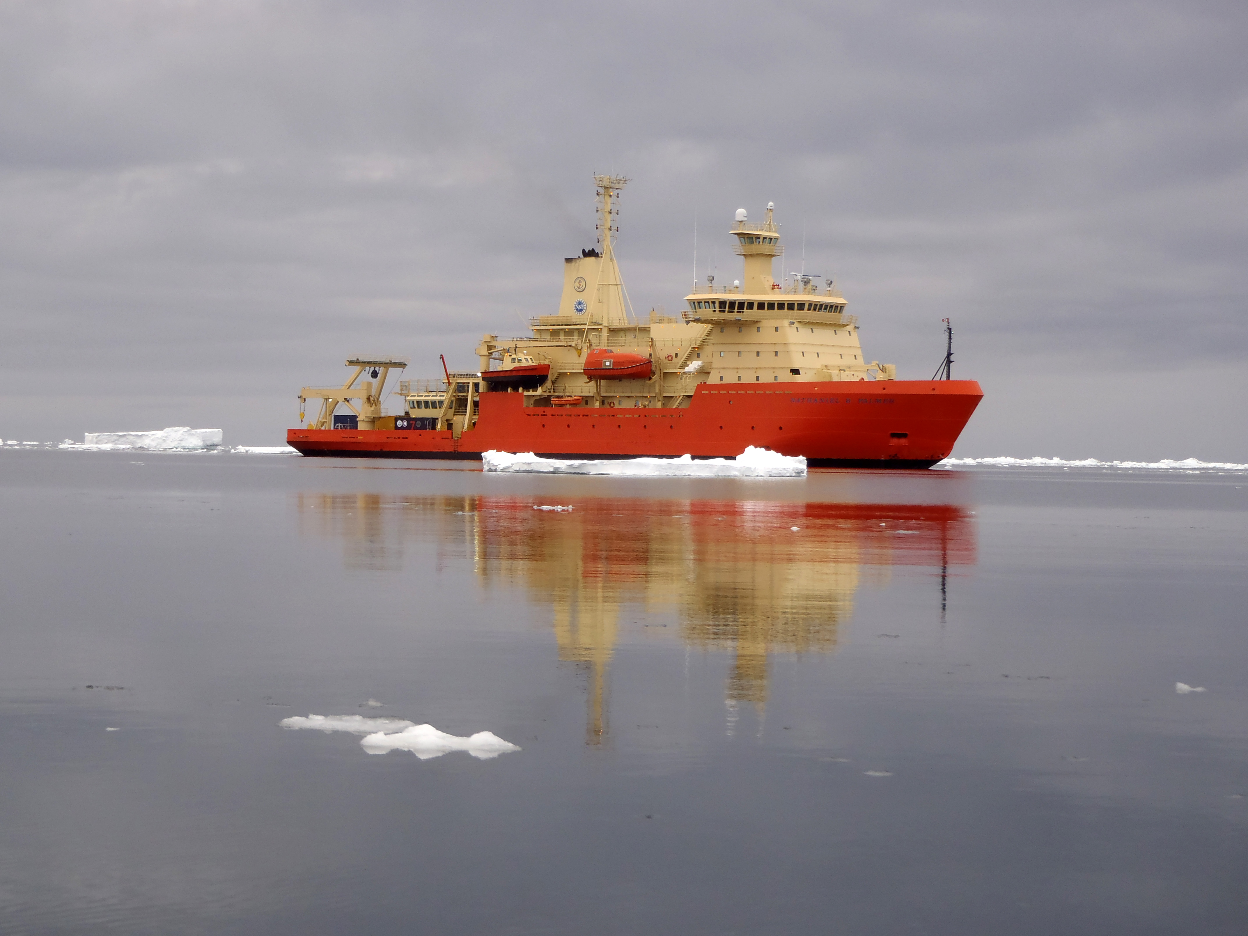 A ship in very calm waters.