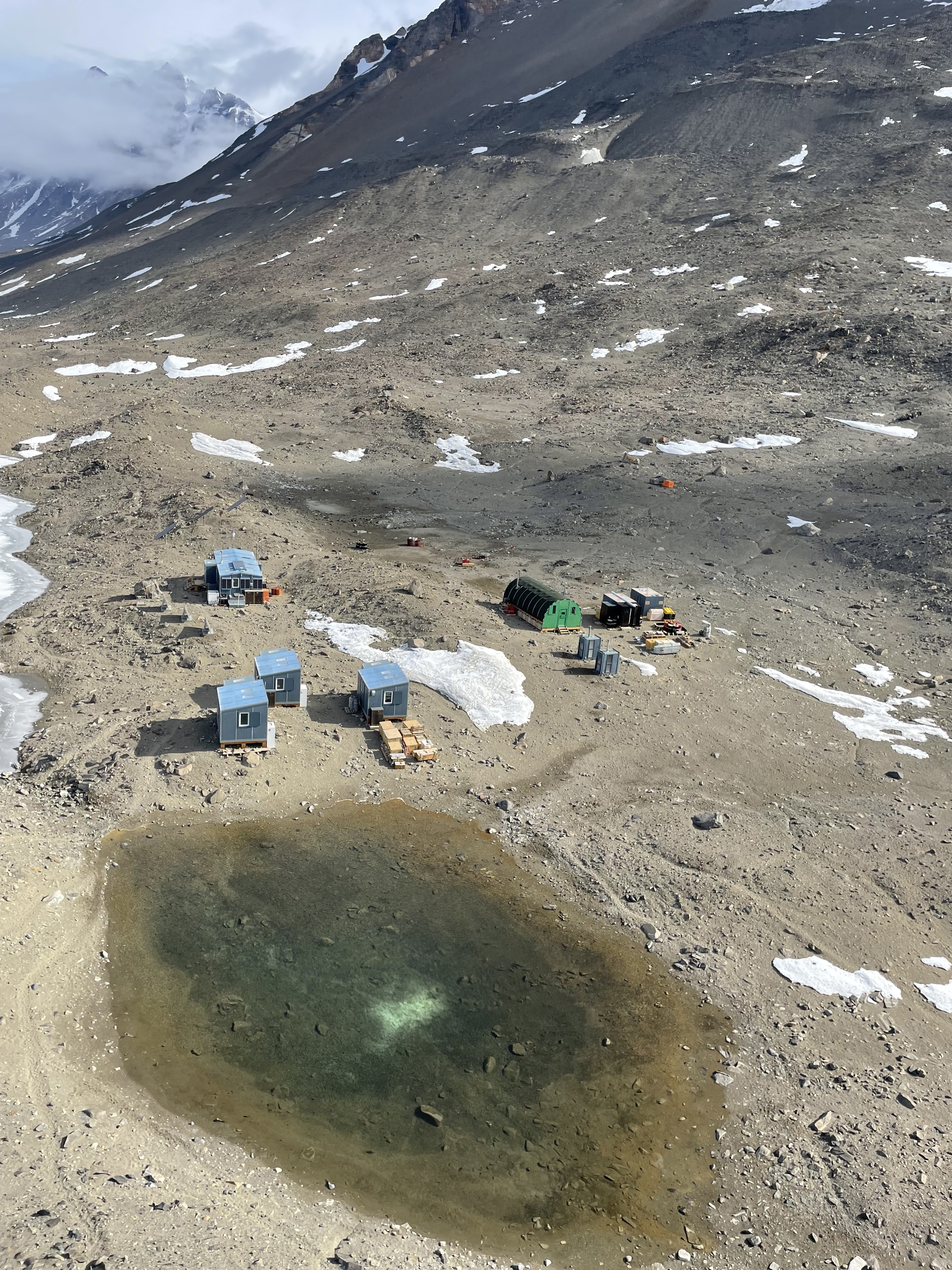 Aerial view of small buildings in a rocky valley.