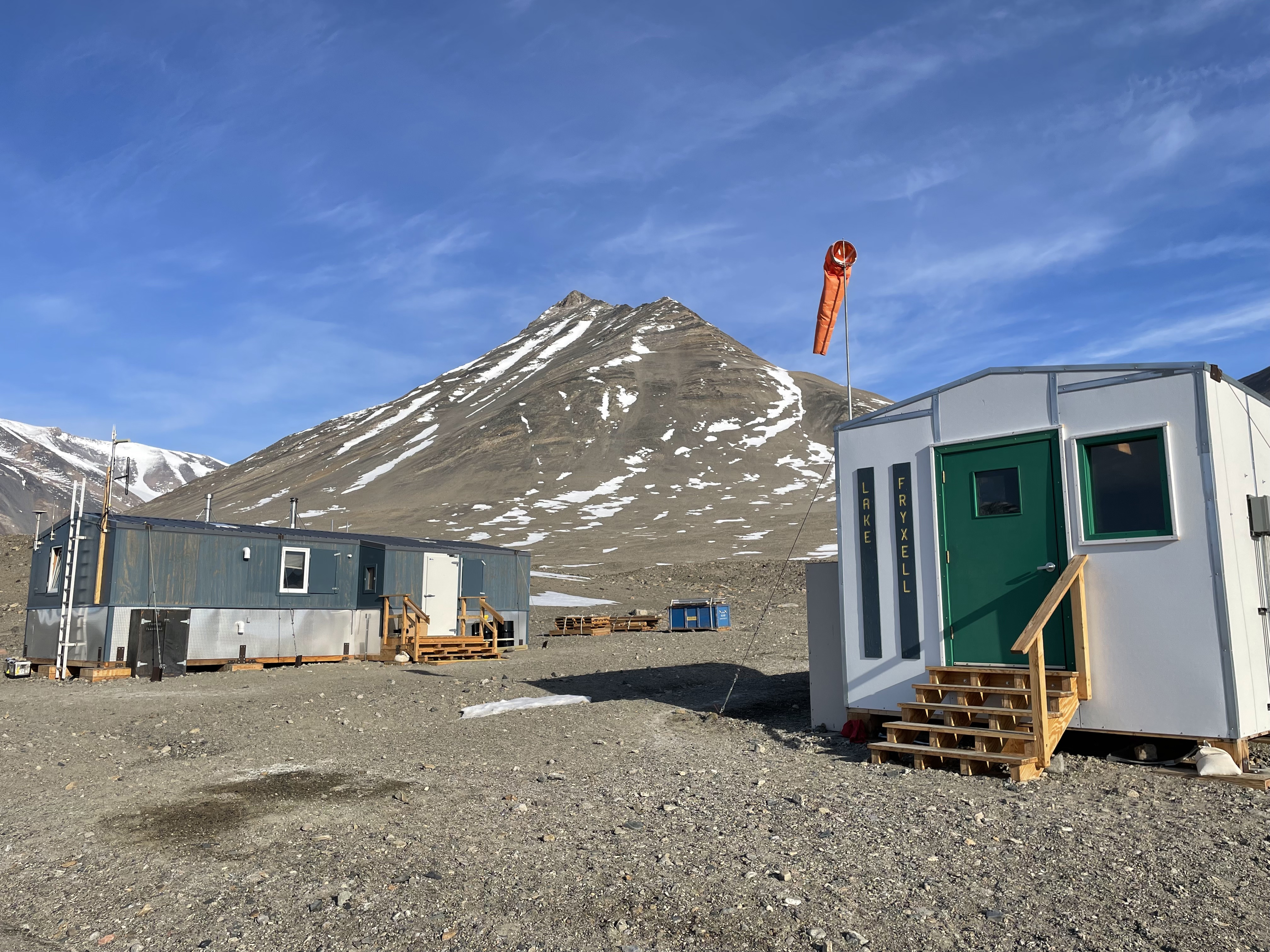 Two buildings in a rocky valley.