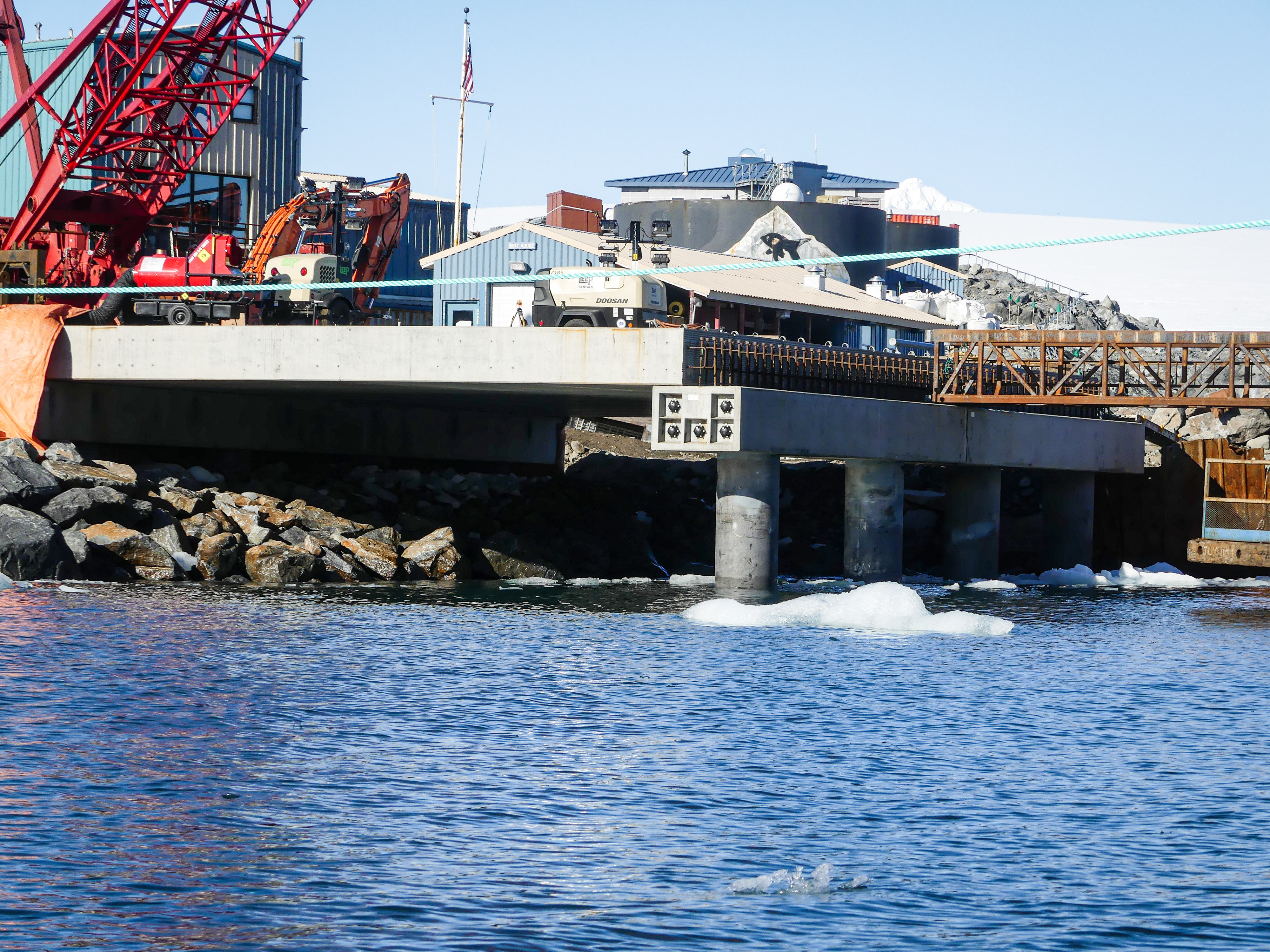 A concrete pier with buildings in the background. 