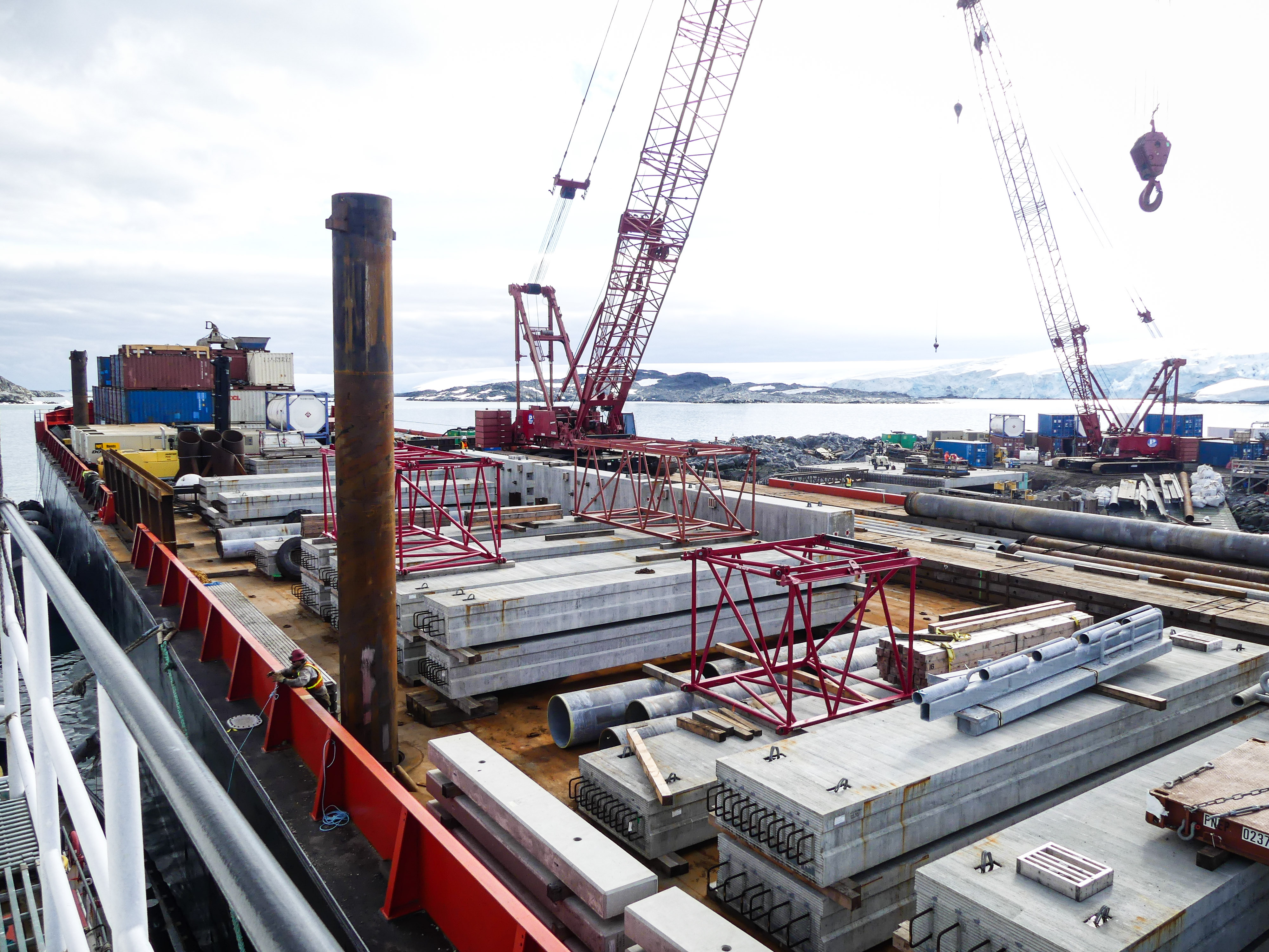 Concrete planks and construction materials on top of a barge. 