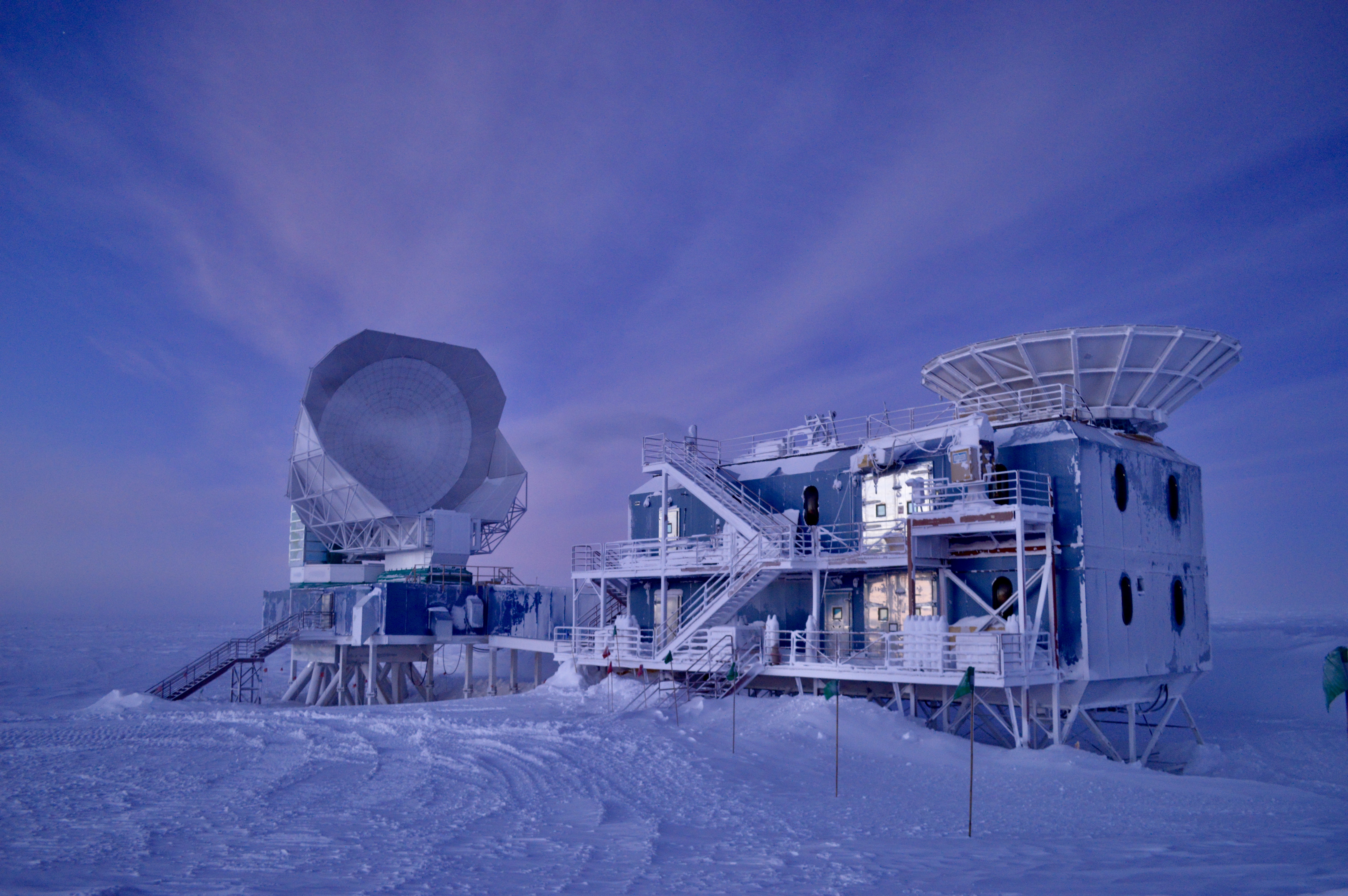 Building with telescope with snow and twilight sky