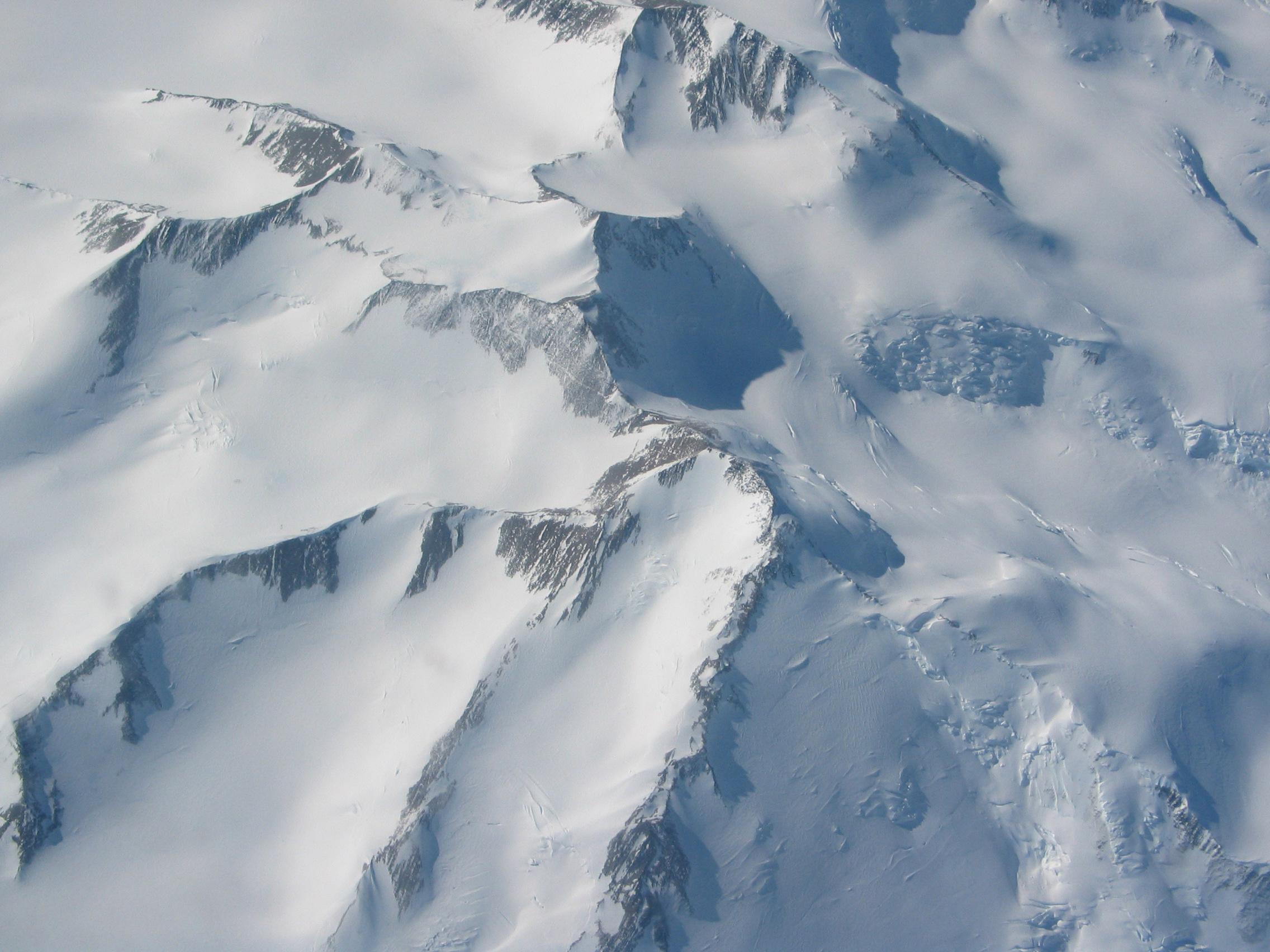 Aerial view of snow covered mountains.