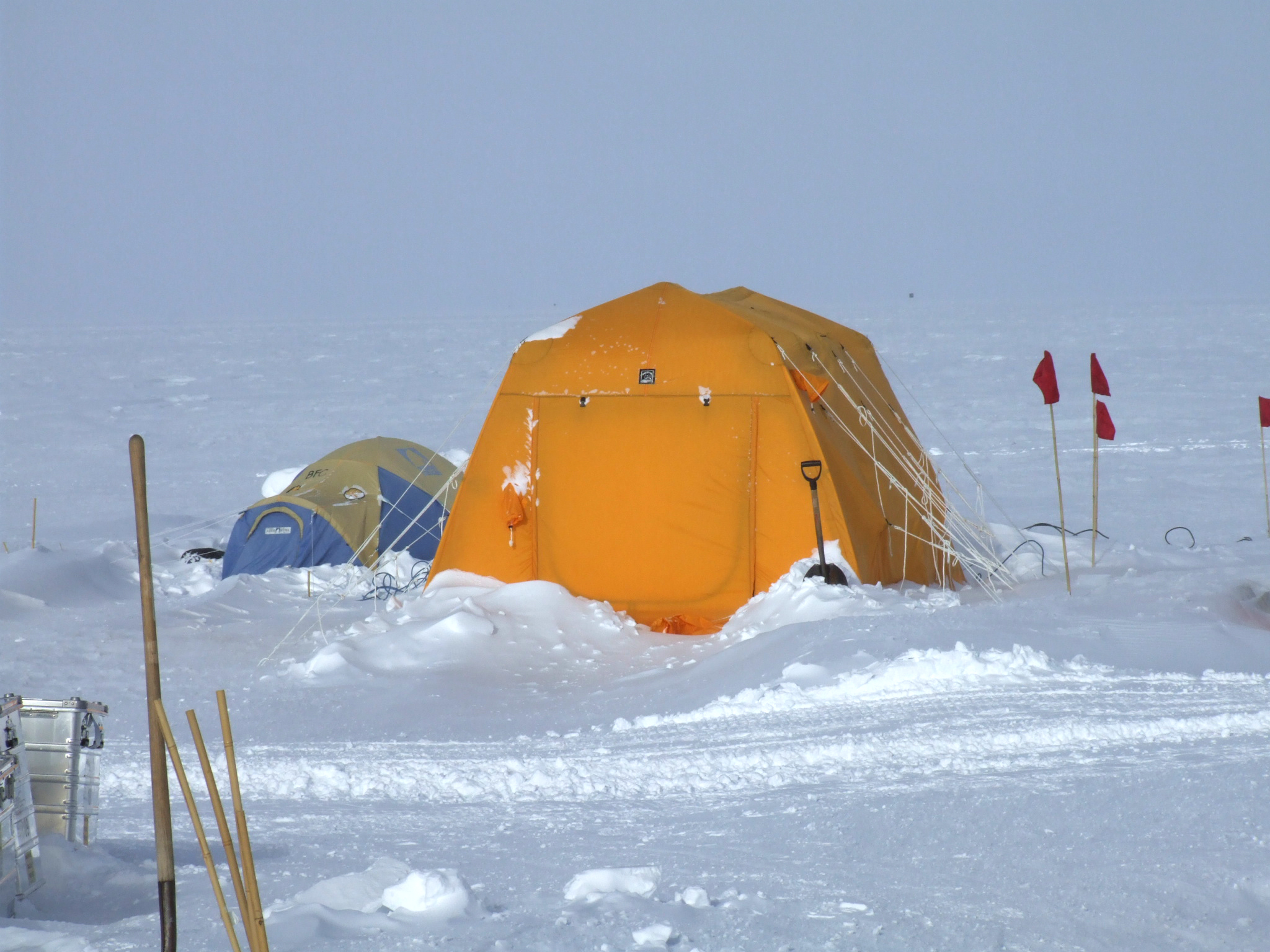 A yellow tent on snow.