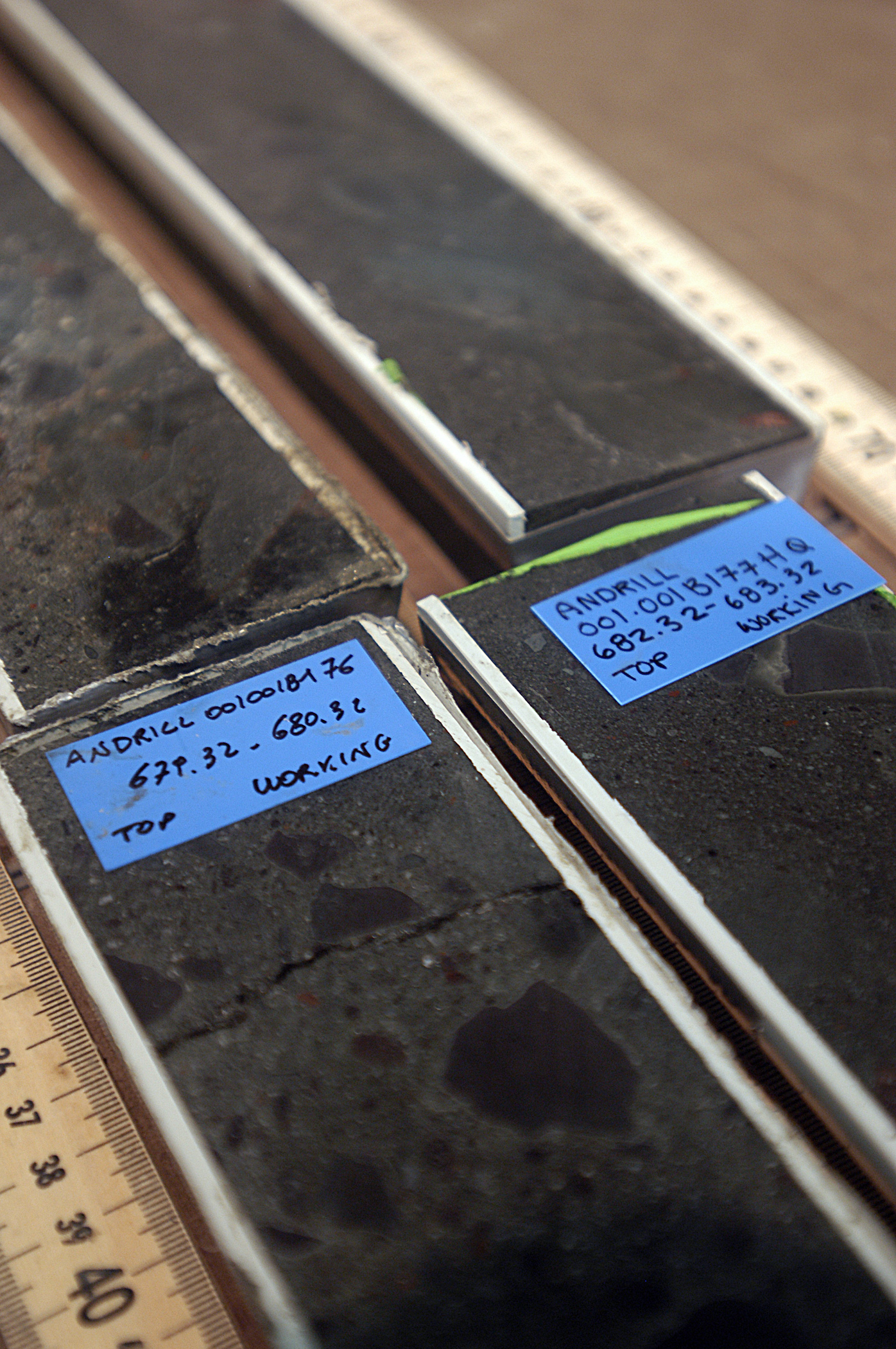 Blue labels identify a black rock core.