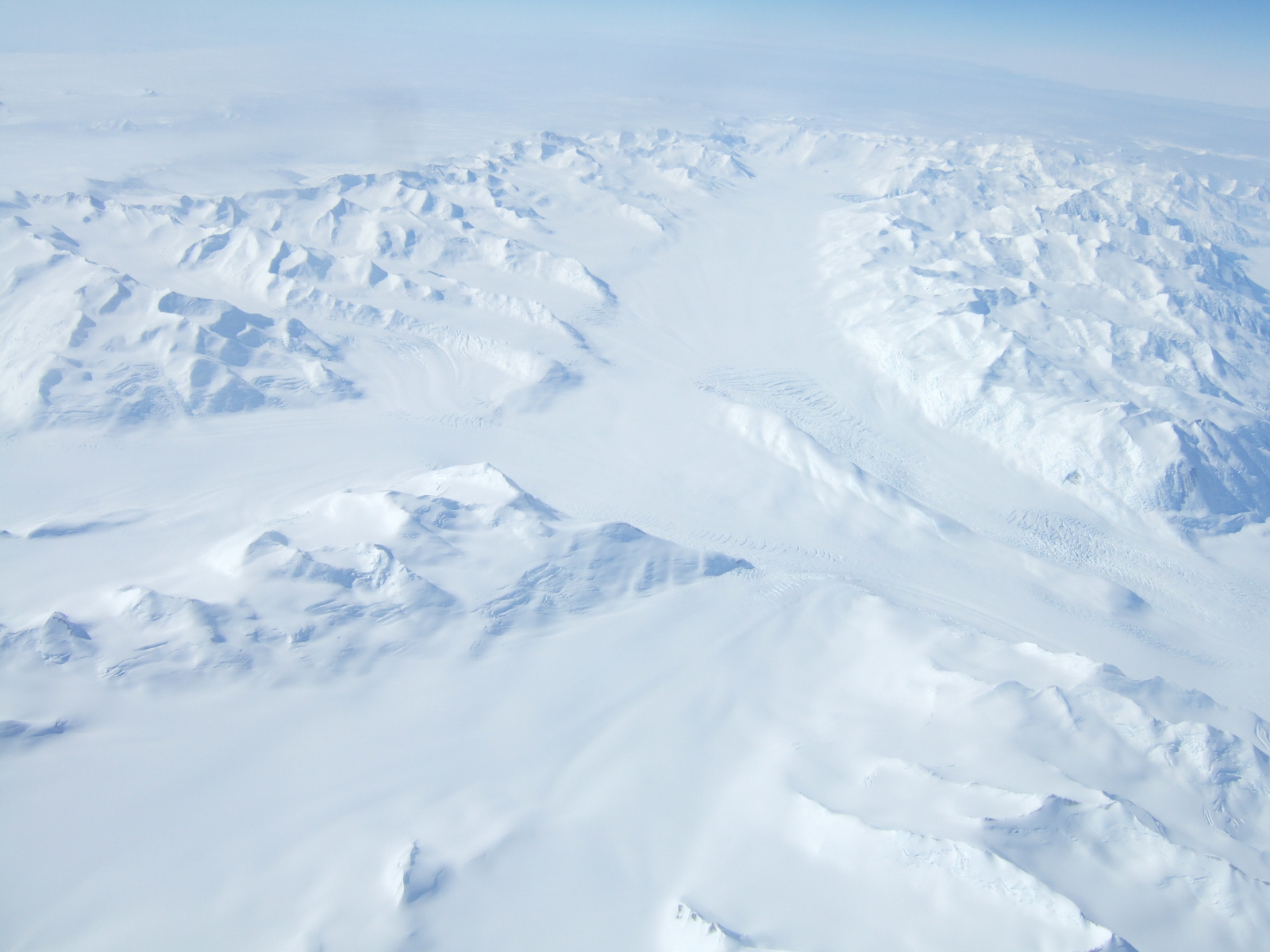 Aerial view of snow covered mountains.