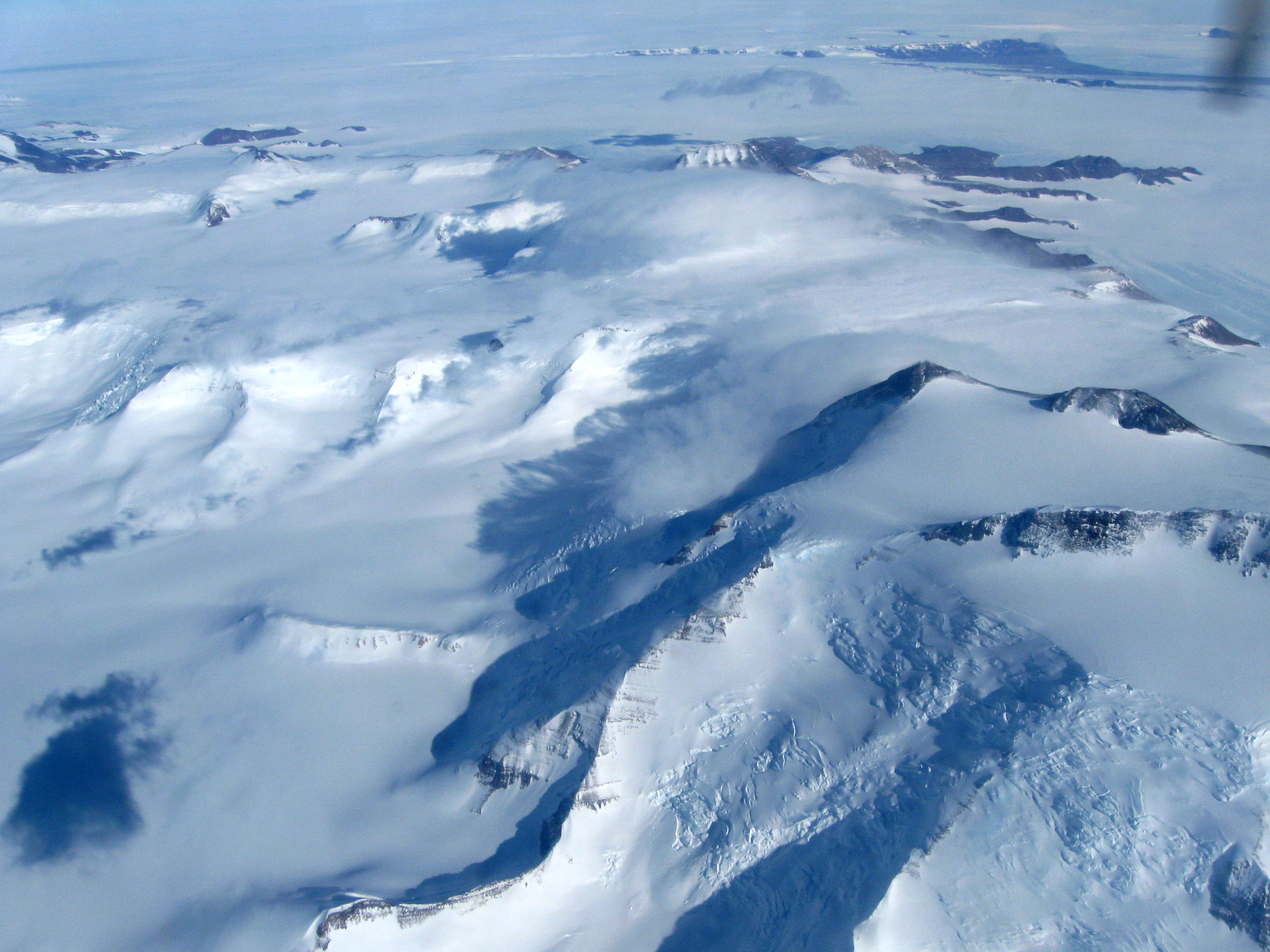 Aerial view of snow covered mountains.