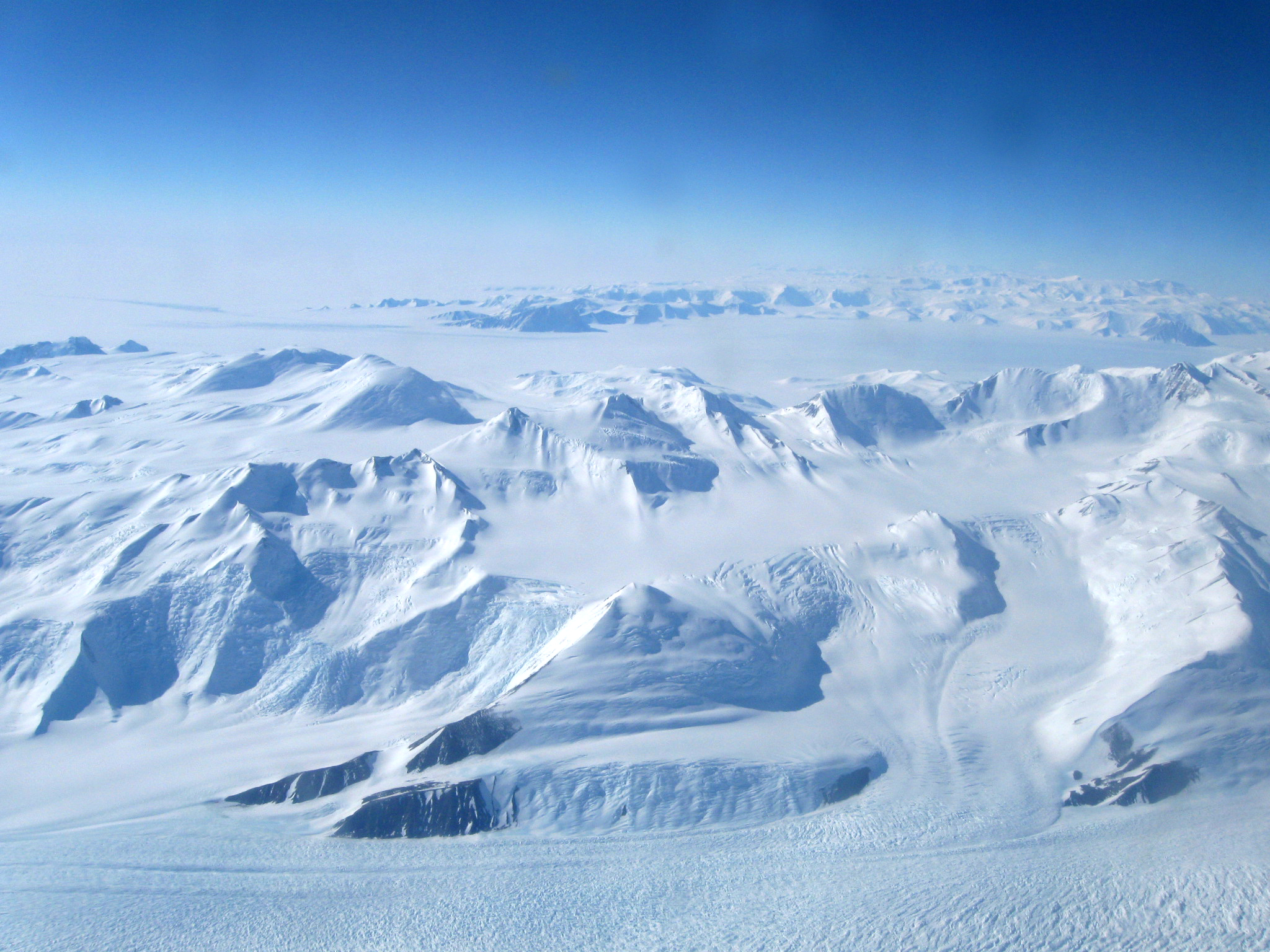 Aerial view of snow covered mountains.