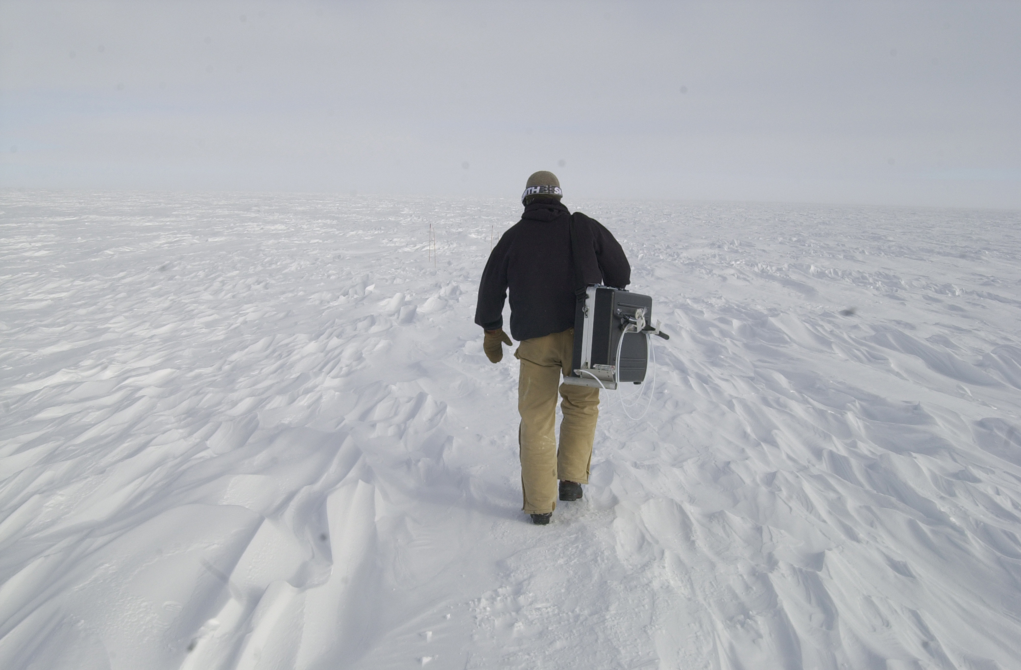 A man walks in the snow.