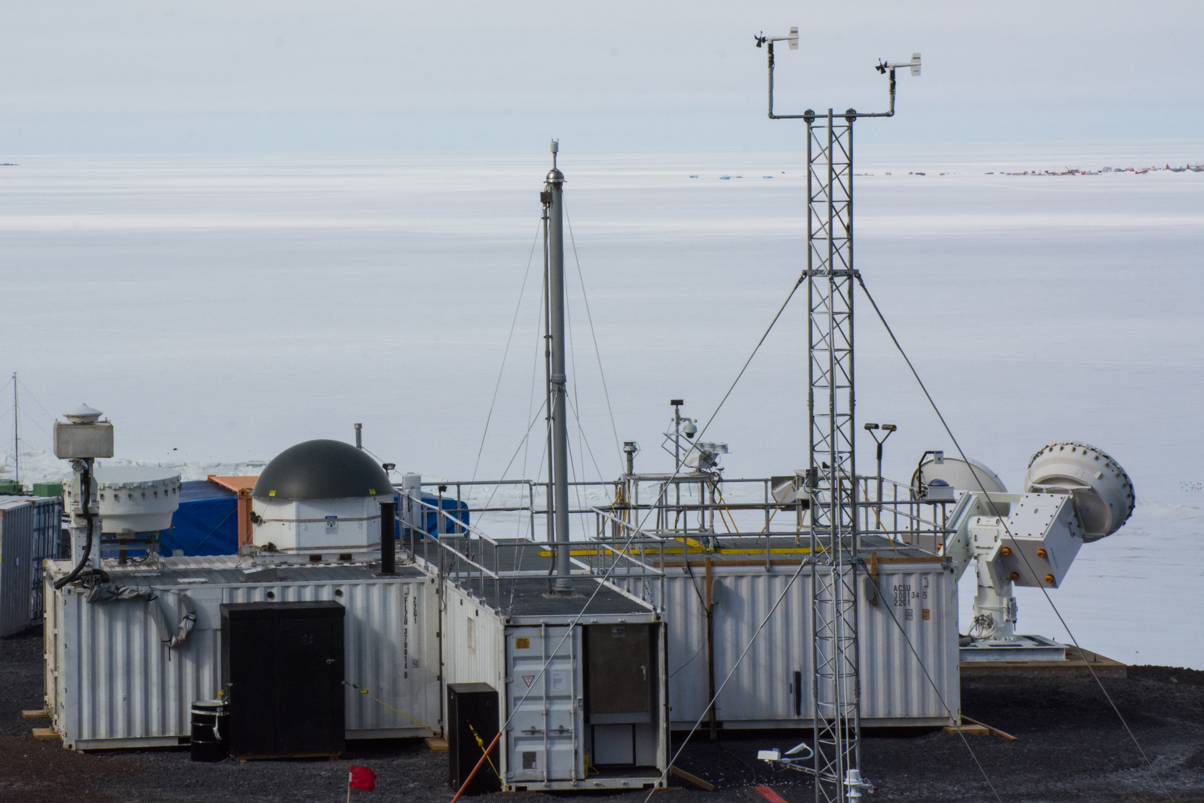 A small building with a radar overlooking the ice shelf