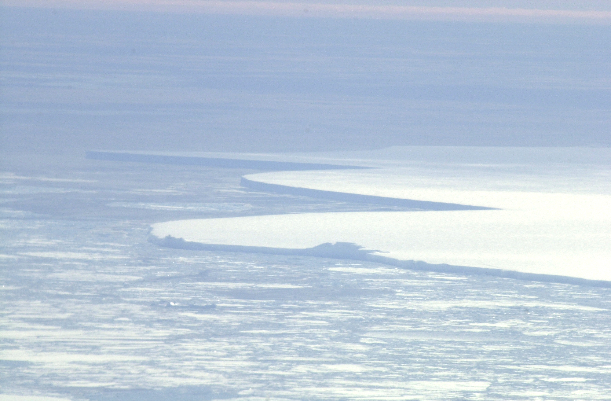 An expanse of snow with curved edges.