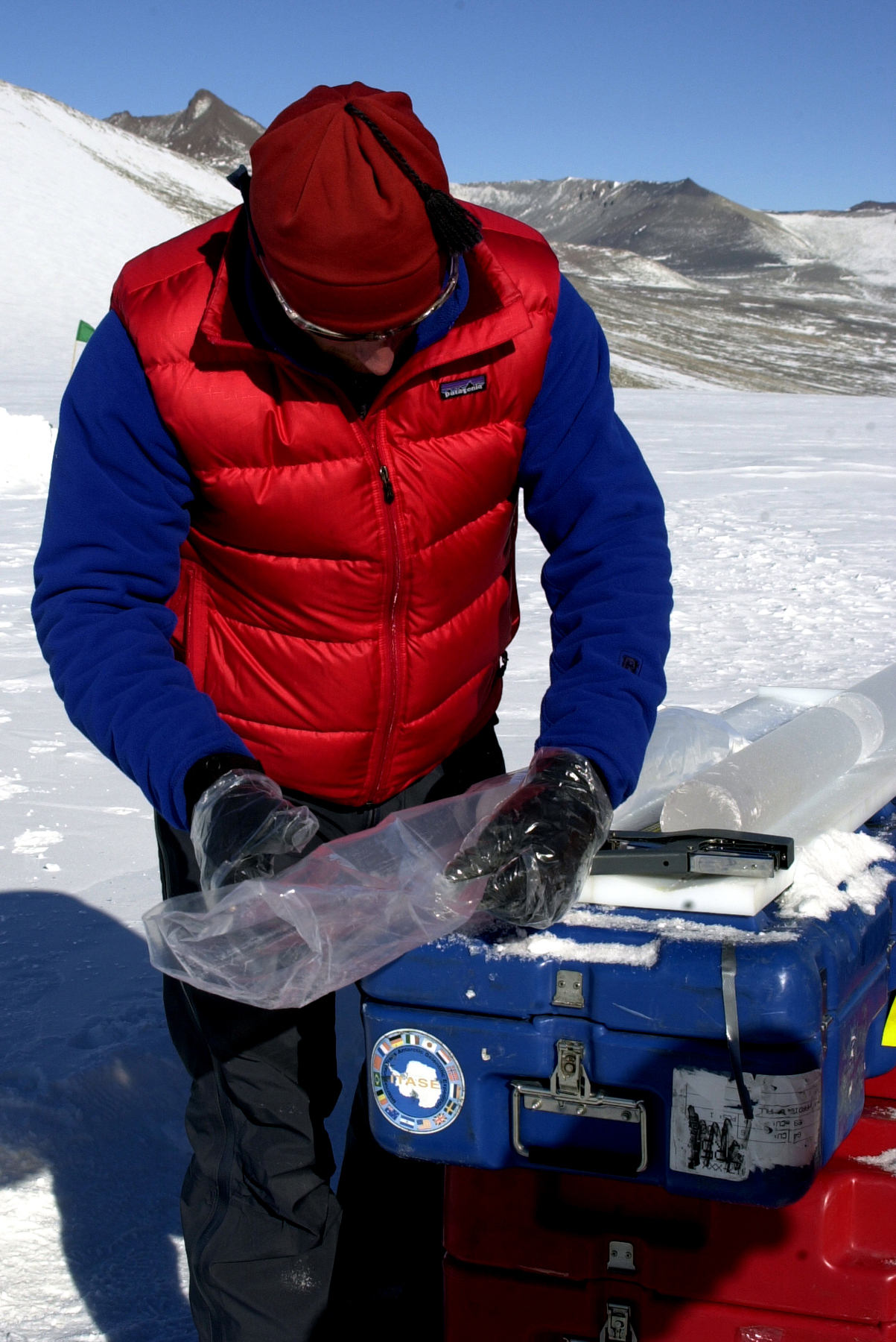 A person holds an ice core.