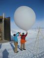 Two people ready to launch a weather balloon.