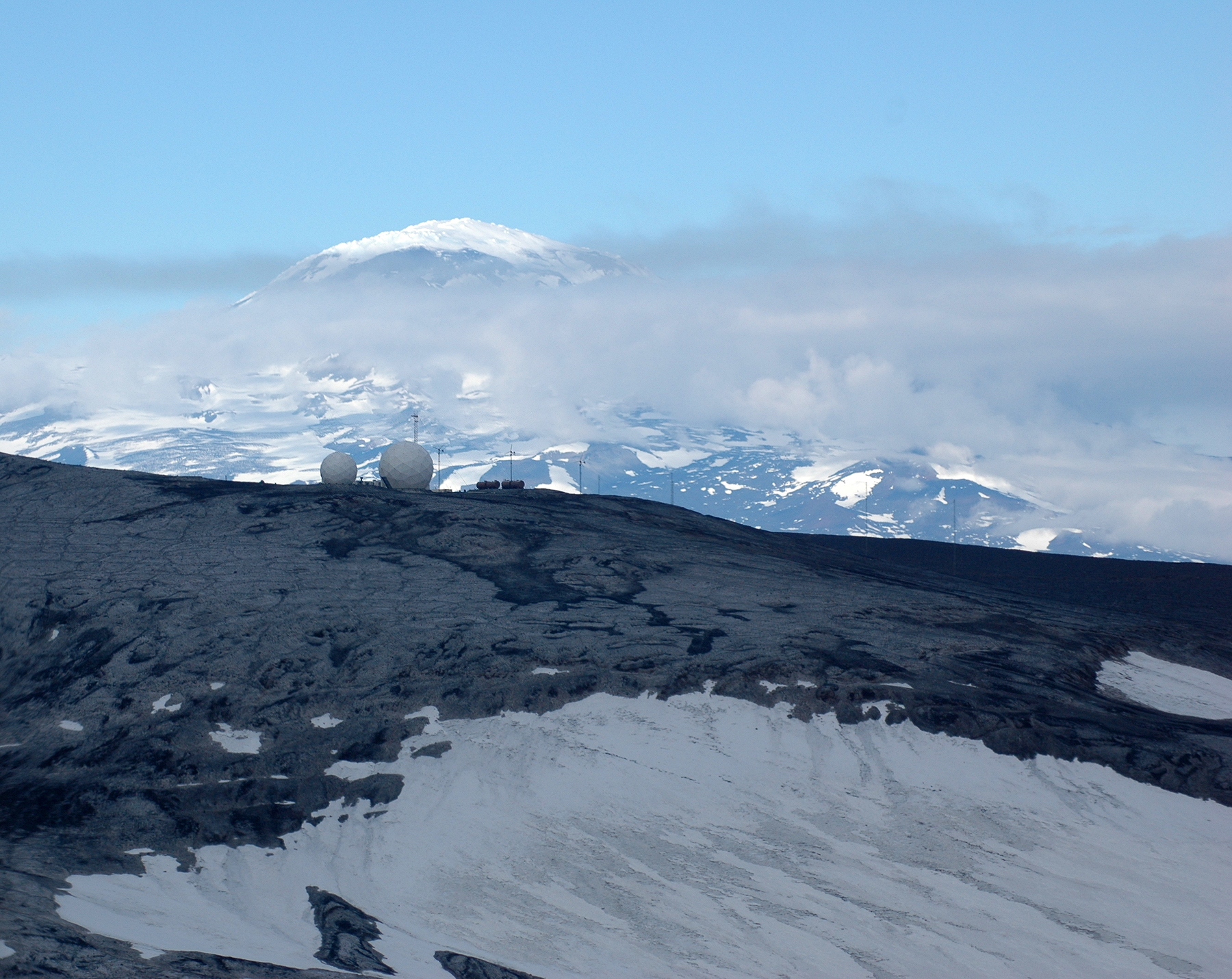 Two large geodesic spheres sitting along a ridge.