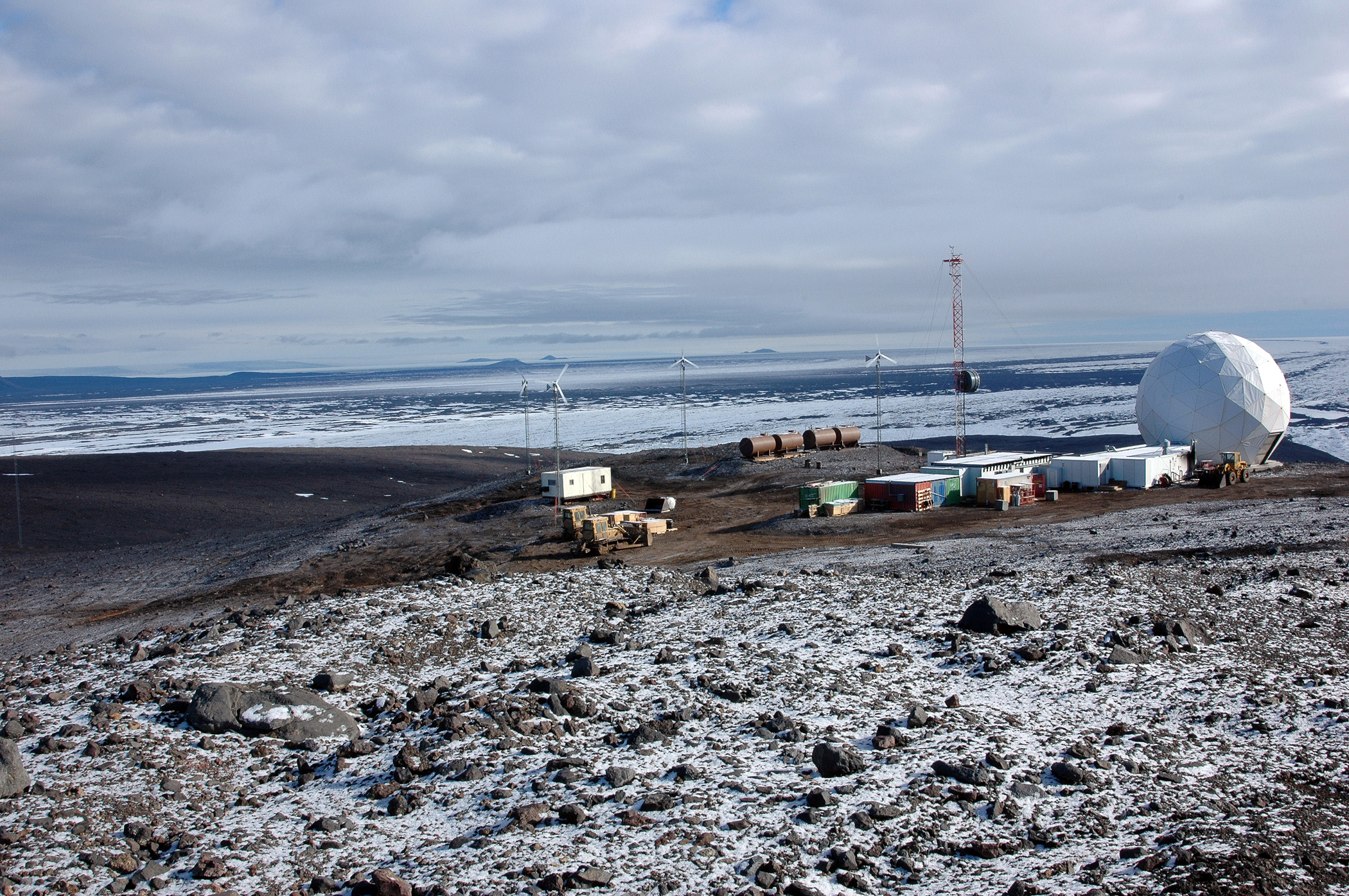 Several buildings on barren landscape.