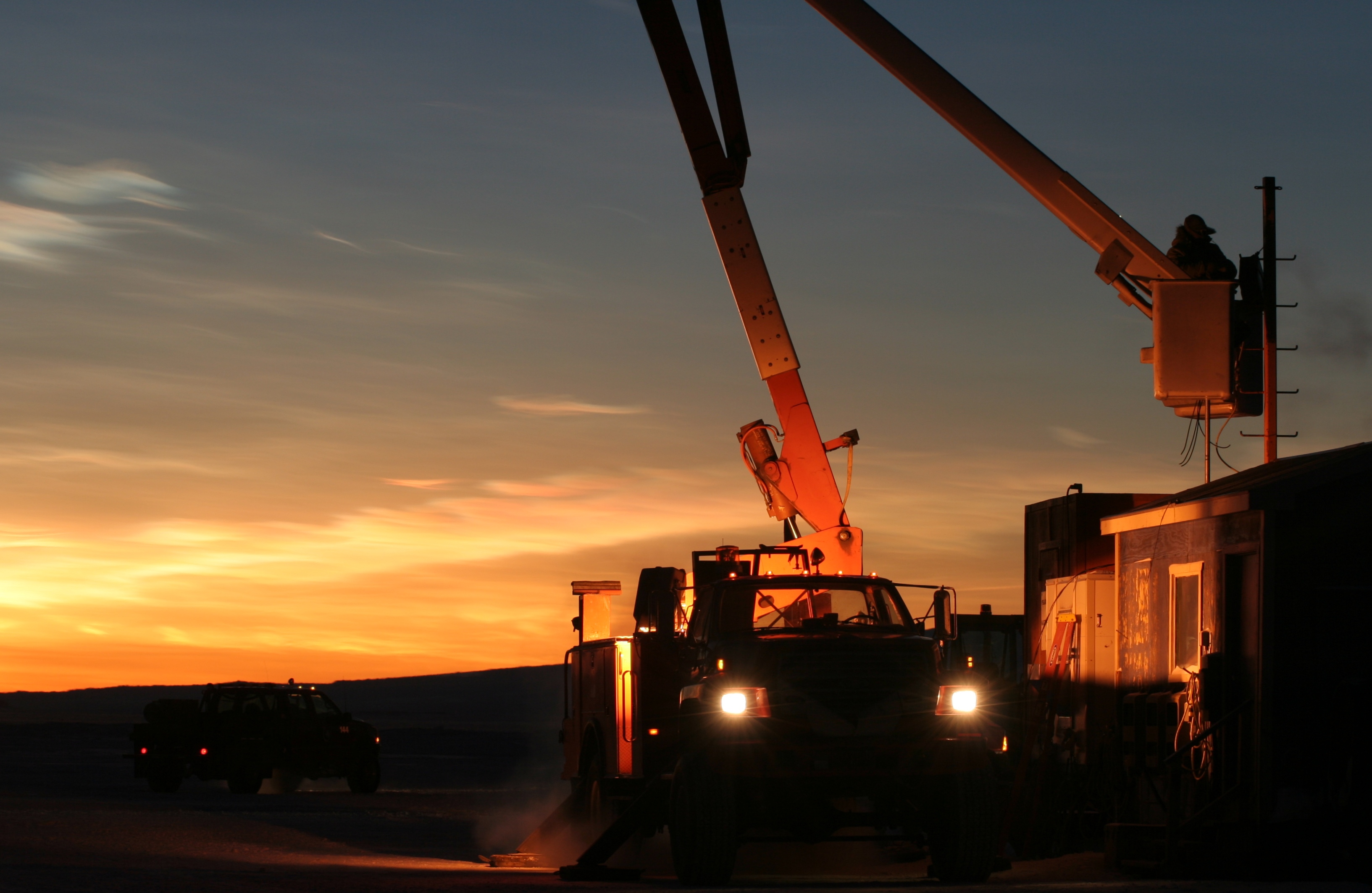 A bucket truck at night.