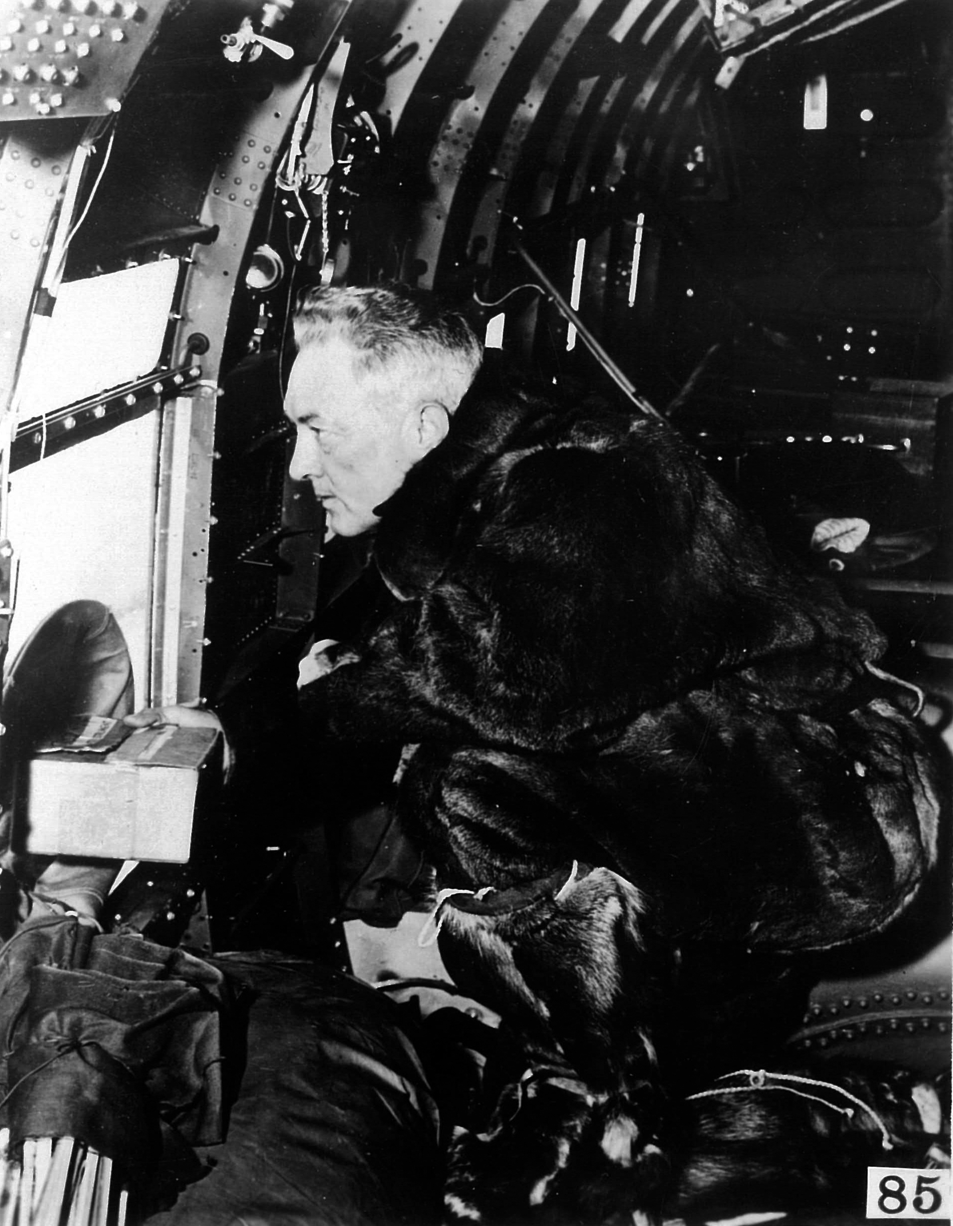 A man looks out an airplane window.