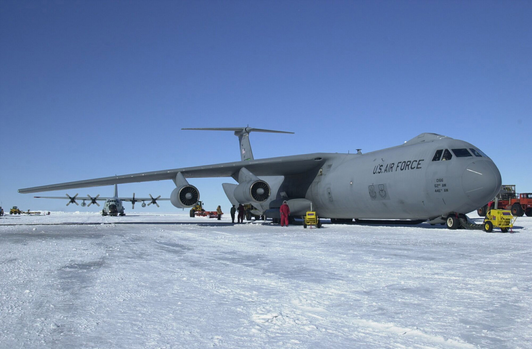 Two large planes sit on ice.