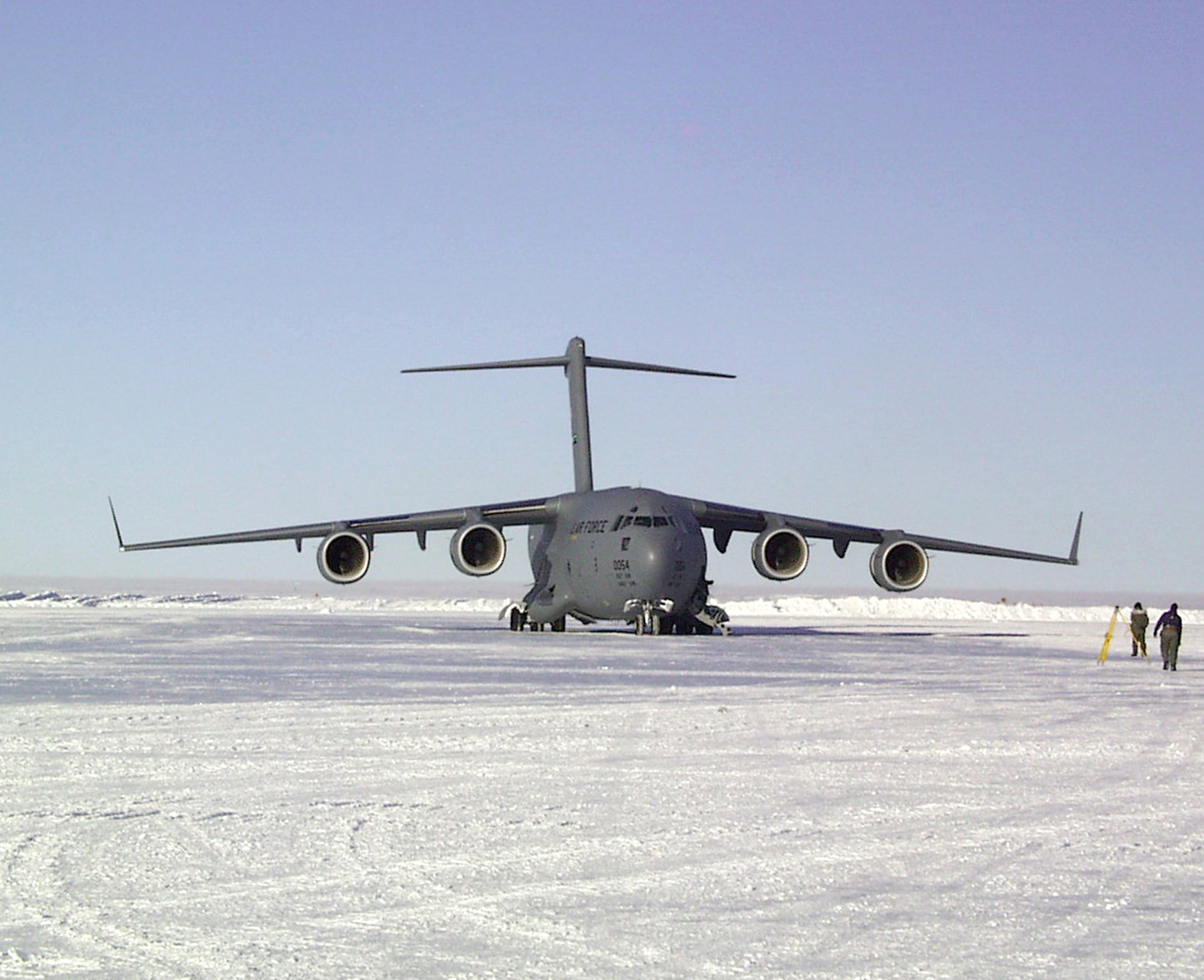 A large jet sits on an ice runway.