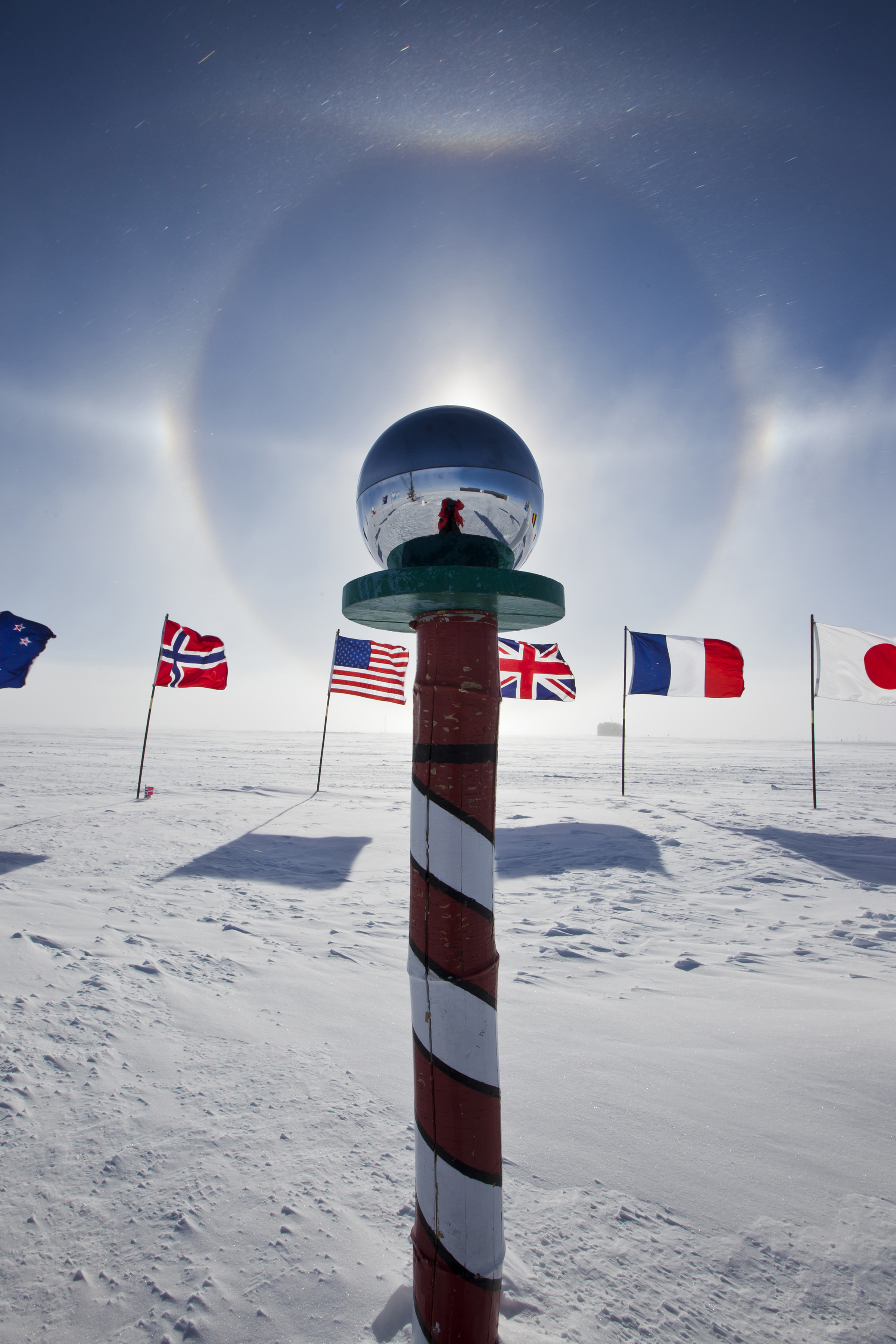 A pole surrounded by flags.