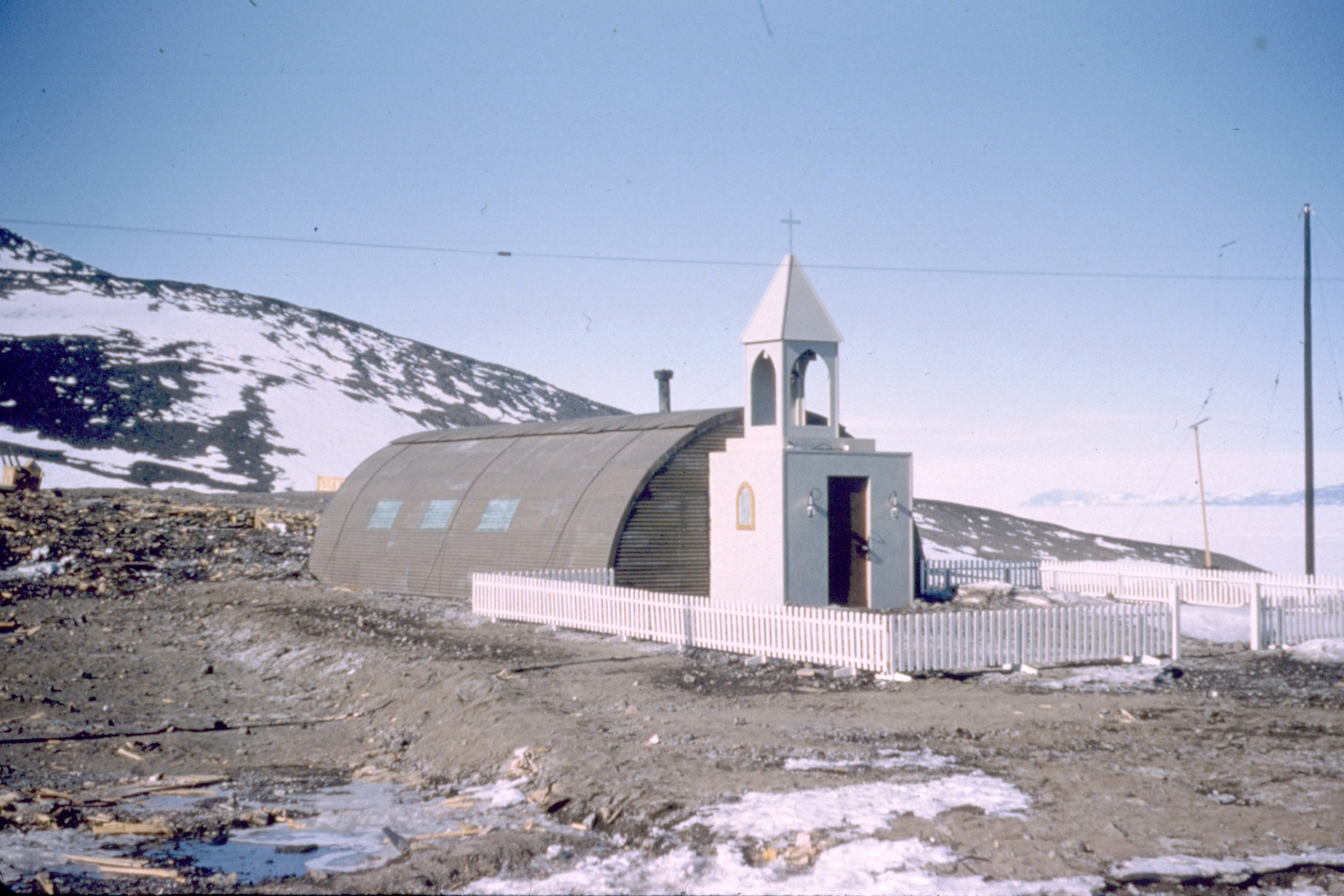 Front of a chapel is attached to a Quonset hut.