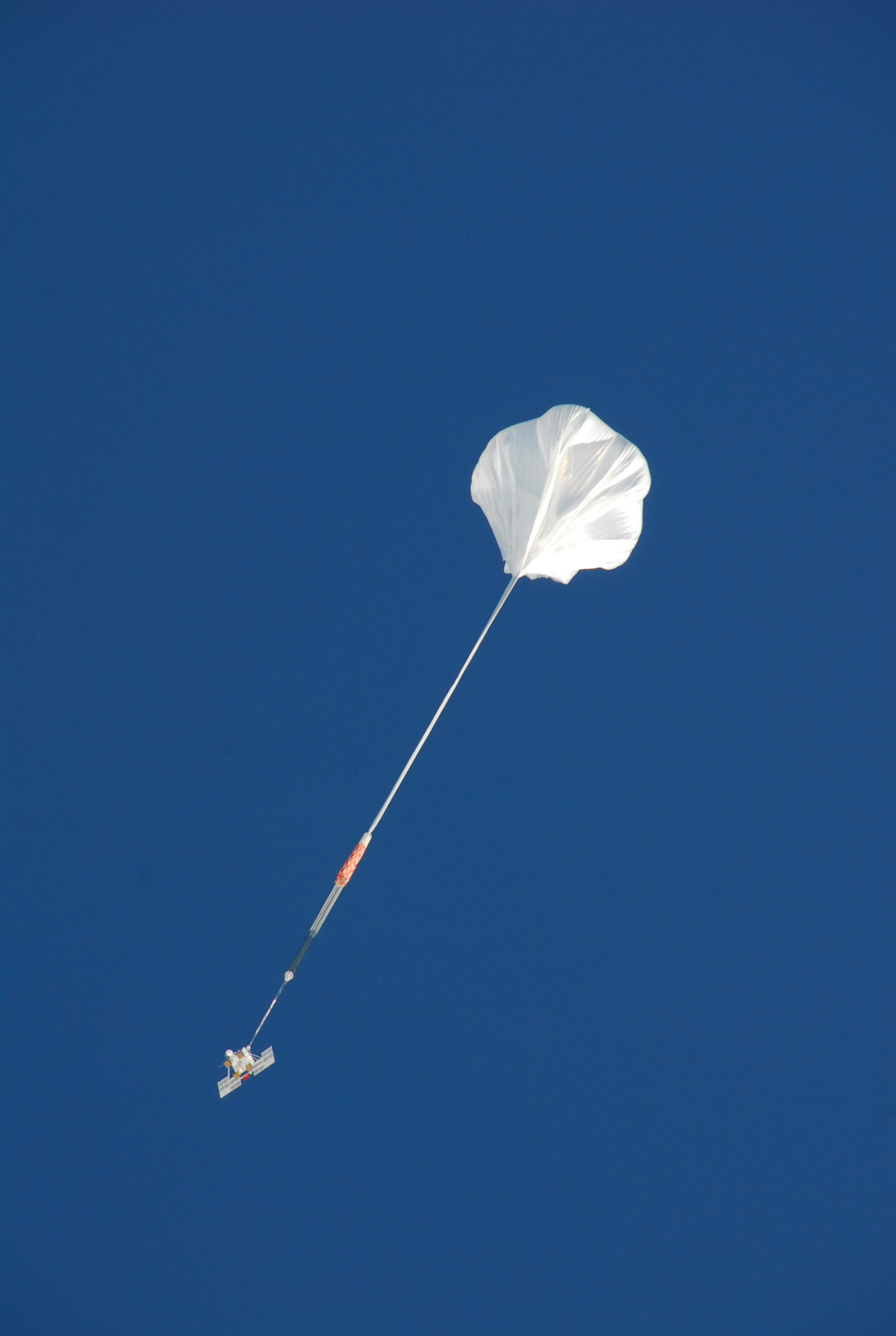 An enormous balloon hovers in the sky.