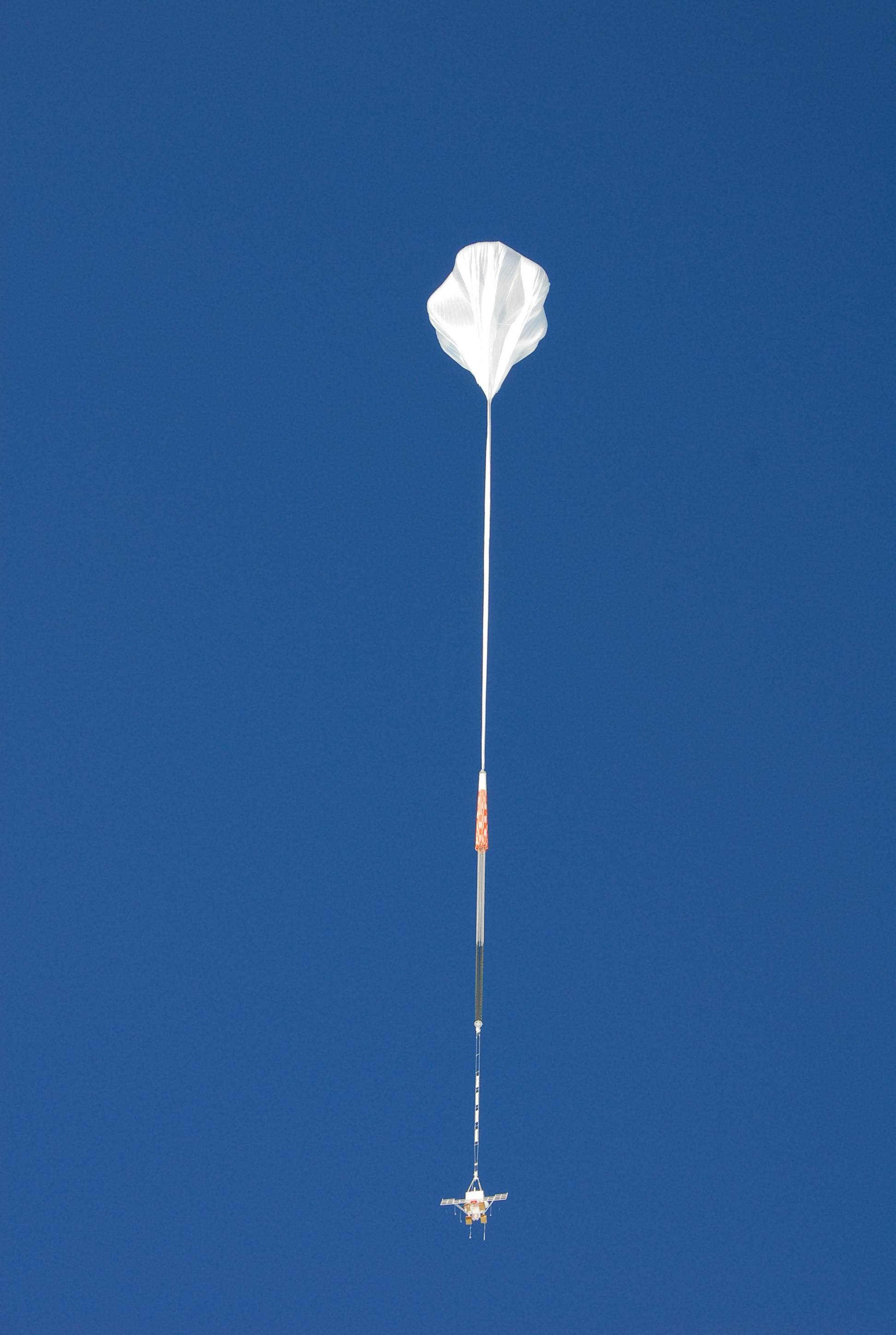 An enormous balloon hovers in the sky.