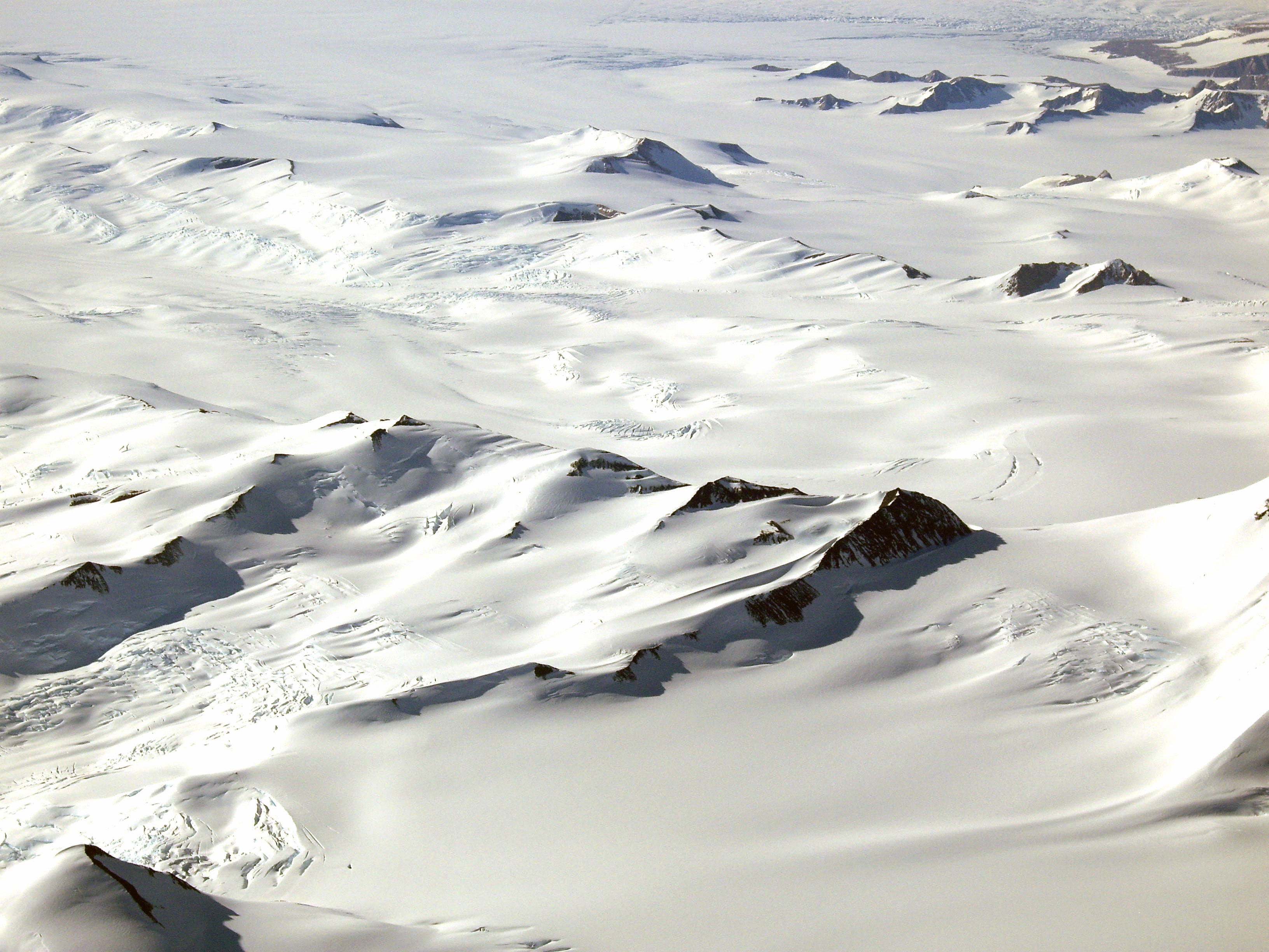 Aerial view of snow covered mountains.