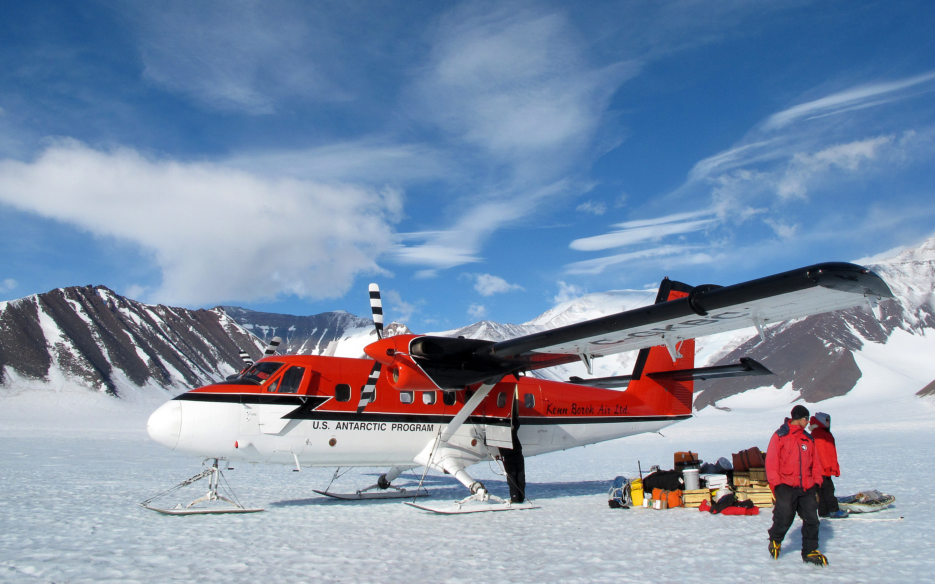 Airplane and people on snow.