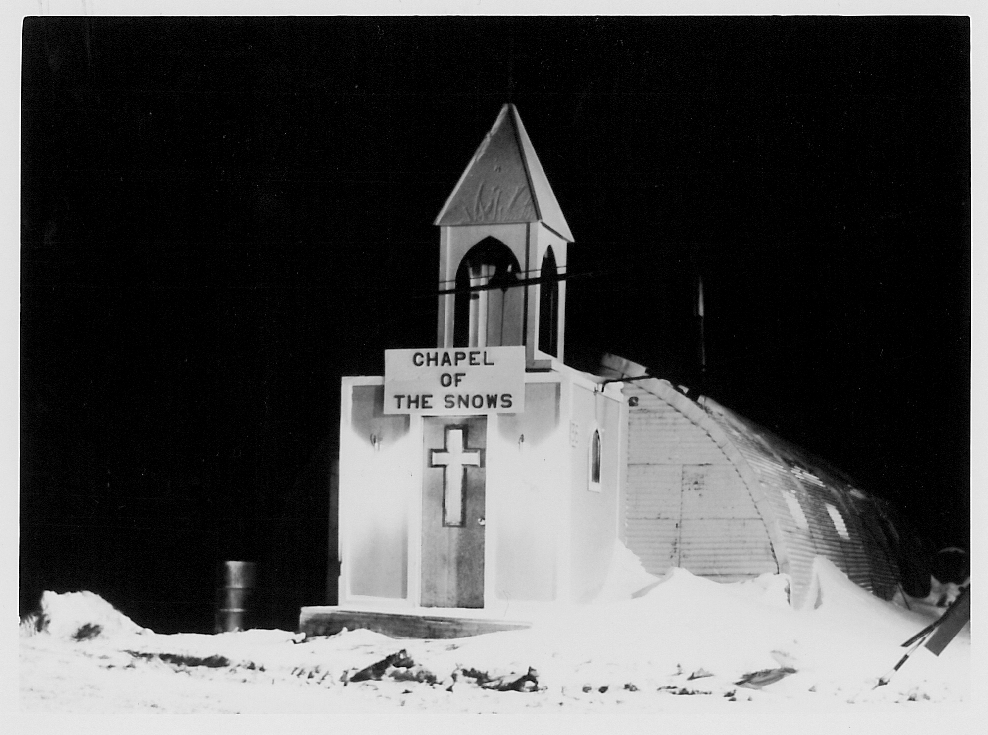 A small chapel lit up at night.