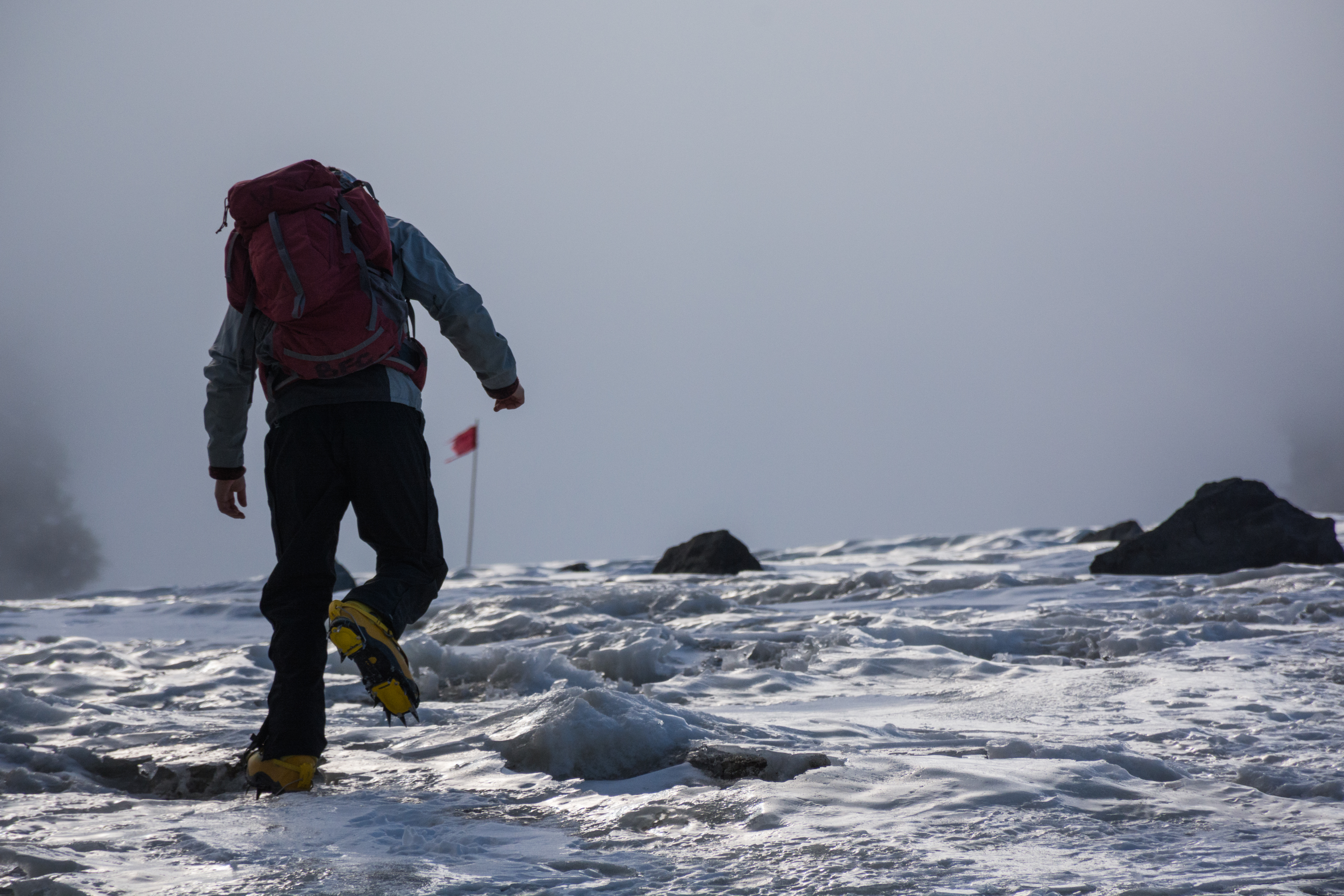 A climber ascends a frozen ice field. 