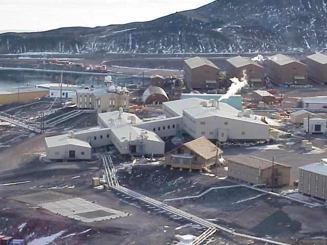 Aerial view of many buildings on rocky terrain.