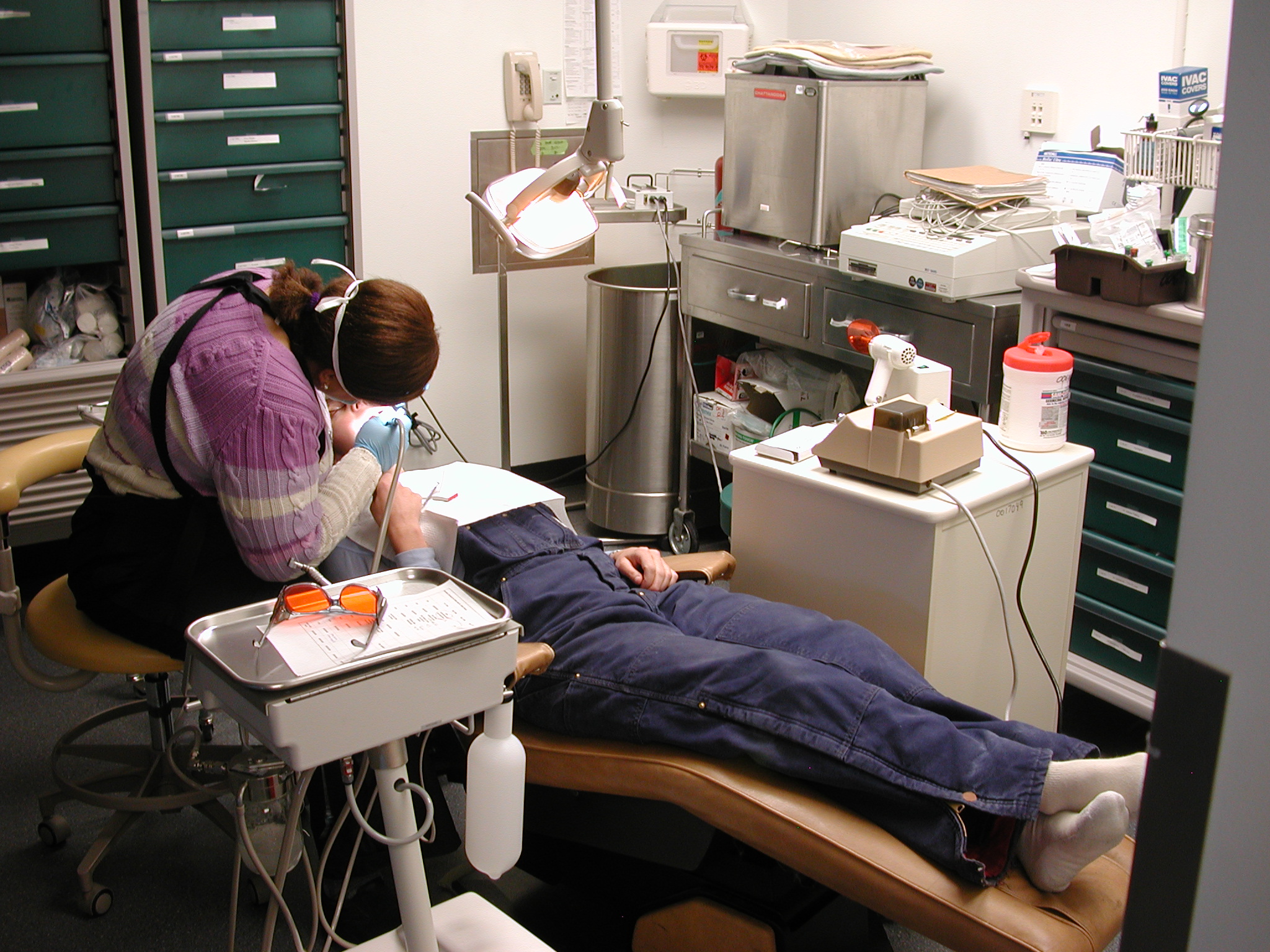 A dentist works on a patient.