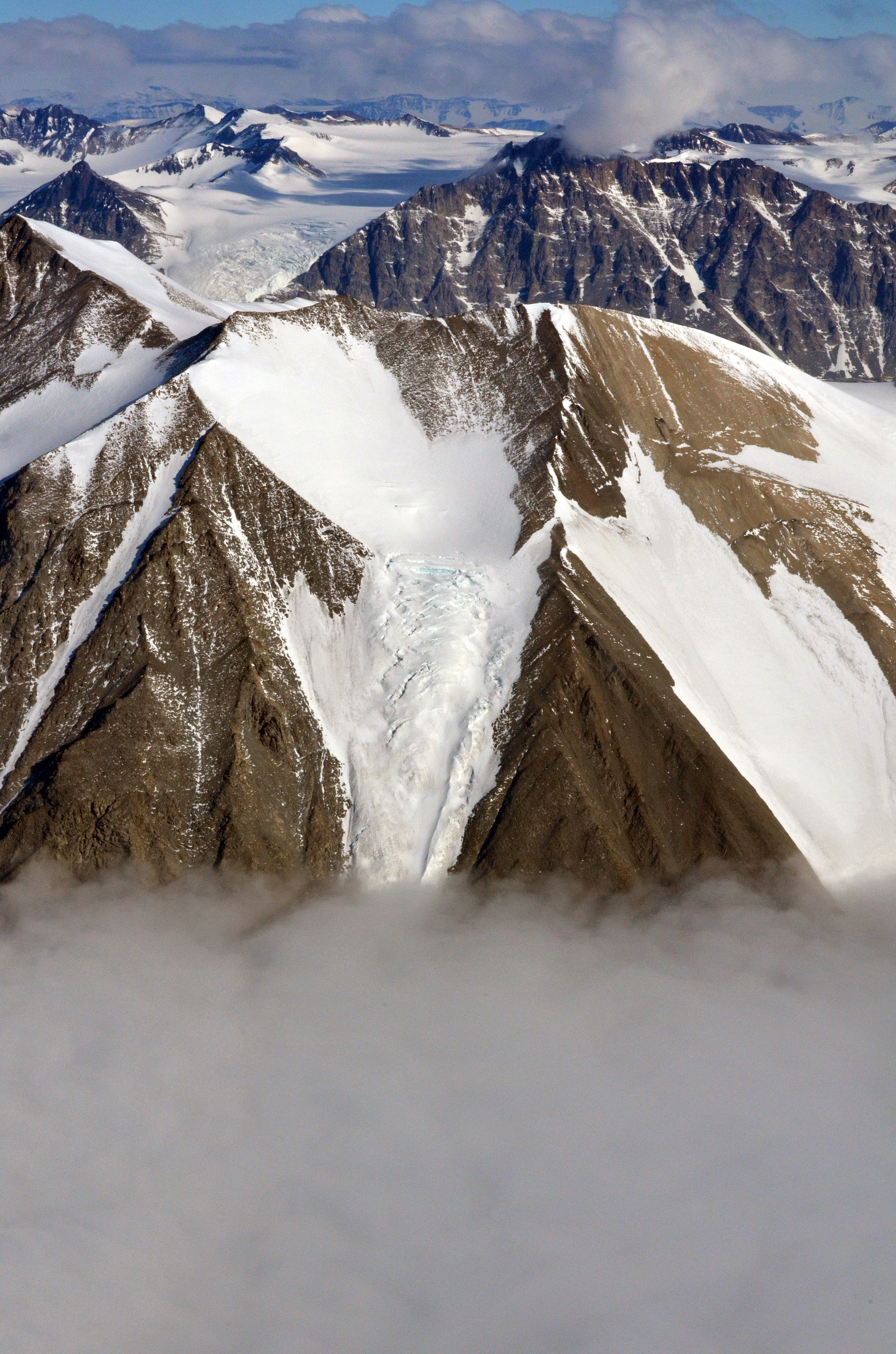 Low clouds sit at base of mountains.